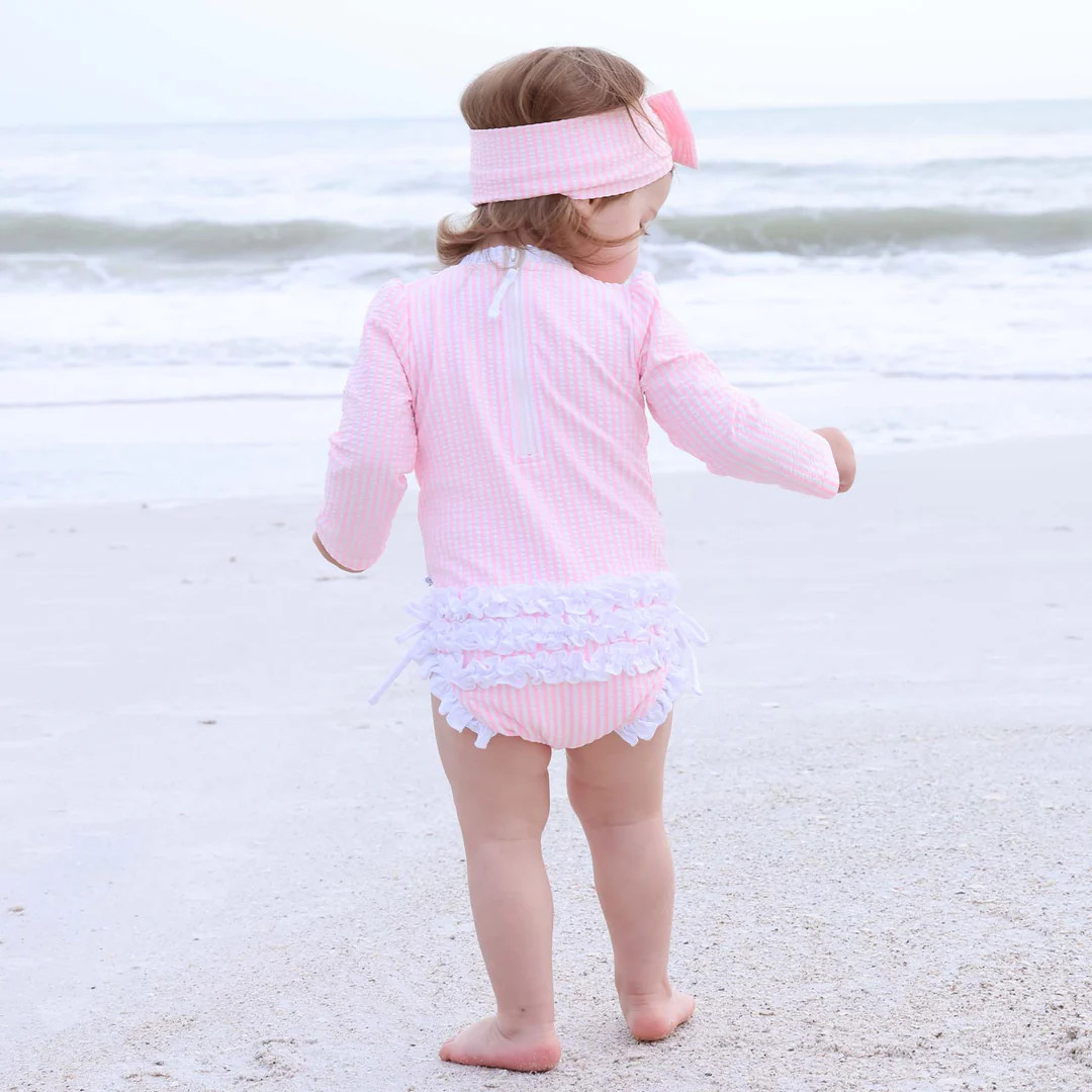 Long Sleeve Rash Guard With Ruffle Bottom | Seersucker Pink | Caden Lane
