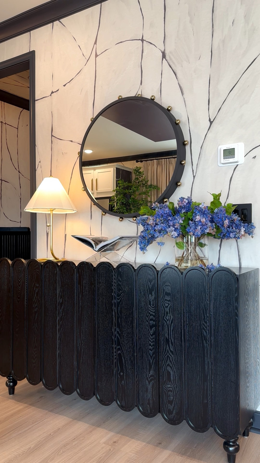 Scalloped dining sideboard from Wayfair with faux flowers from Afloral and Mizti light with lamp shade and studded mirrror

#LTKHome #LTKspring