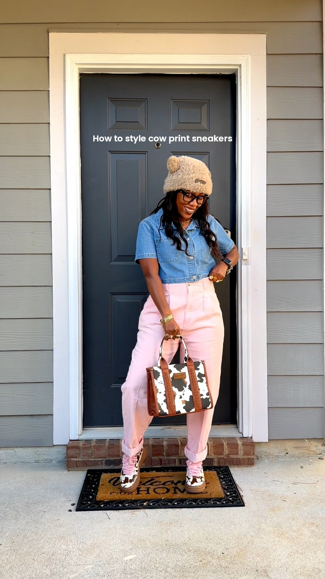 How to style cow print sneakers with a denim short sleeve crop top, pink high waisted corduroy pants, brown fluffy hat, and cow print purse

#LTKootd #LTKOver40 #LTKPetite