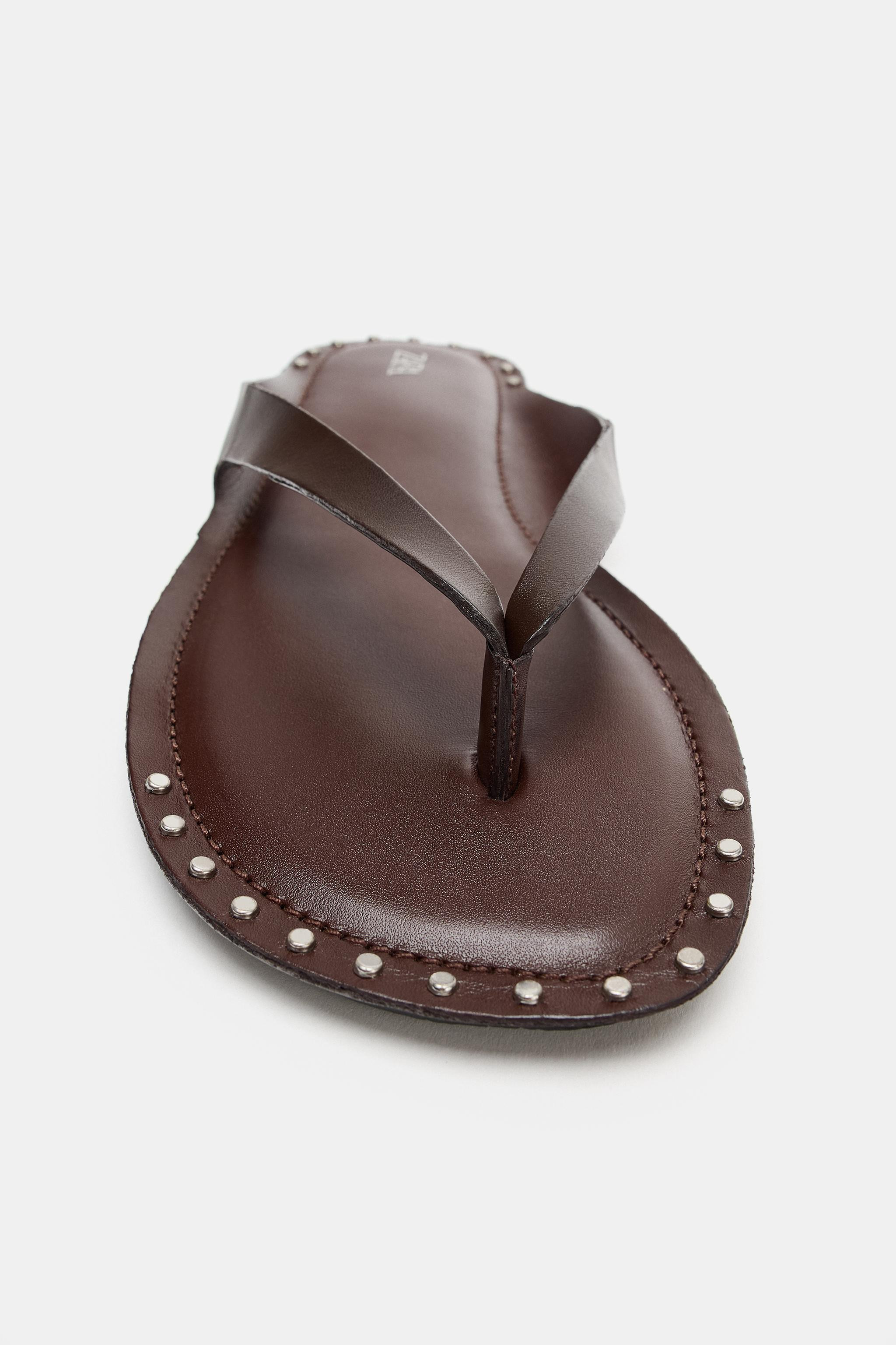 Model height: 181 cmFlat leather sandals. Stud detail around the edge. Toe-post design. Rounded t... | Zara UK