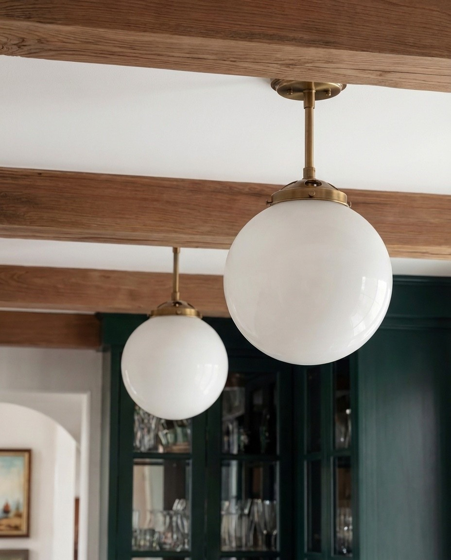 Shop the Look:
• Deep green paneled cabinetry
• Brass cabinet pulls + knobs
• Marble countertops (soft gray veining)
• Glass-front upper cabinets
• Built-in beverage/wine fridge
• Vintage-style runner rug (neutral tones)
• White globe pendant lights
• Exposed wood ceiling beams
• Open wood shelving
• Clear glassware set
• Ceramic vase with branches
• Countertop coffee machine
• Stoneware mugs + tray
• Light wood flooring
• Arched doorway with framed artwork
• coffee machine
• brass gold faucet 
• green vase
• letter bistro cup 
• globe pendant light 
Brass wall sconce 
Brass hand pulls

#LTKFindsUnder100 #LTKHome #LTKSaleAlert