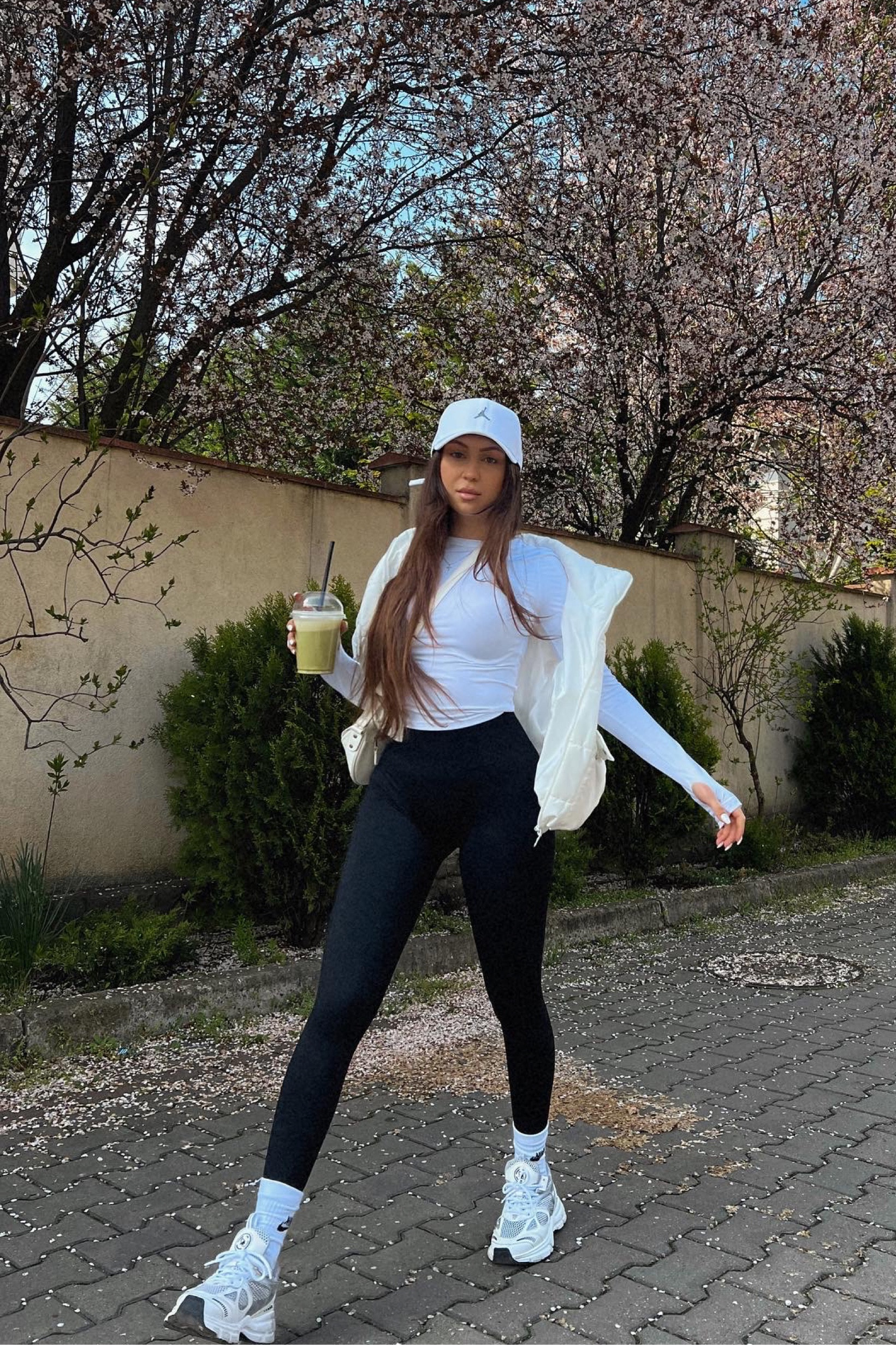 This is my favourite outfit to grab a Matcha Latte with my mom or best friends on a Sunday at noon—stretchy black leggings with a slim top styled with some 90s trainers.