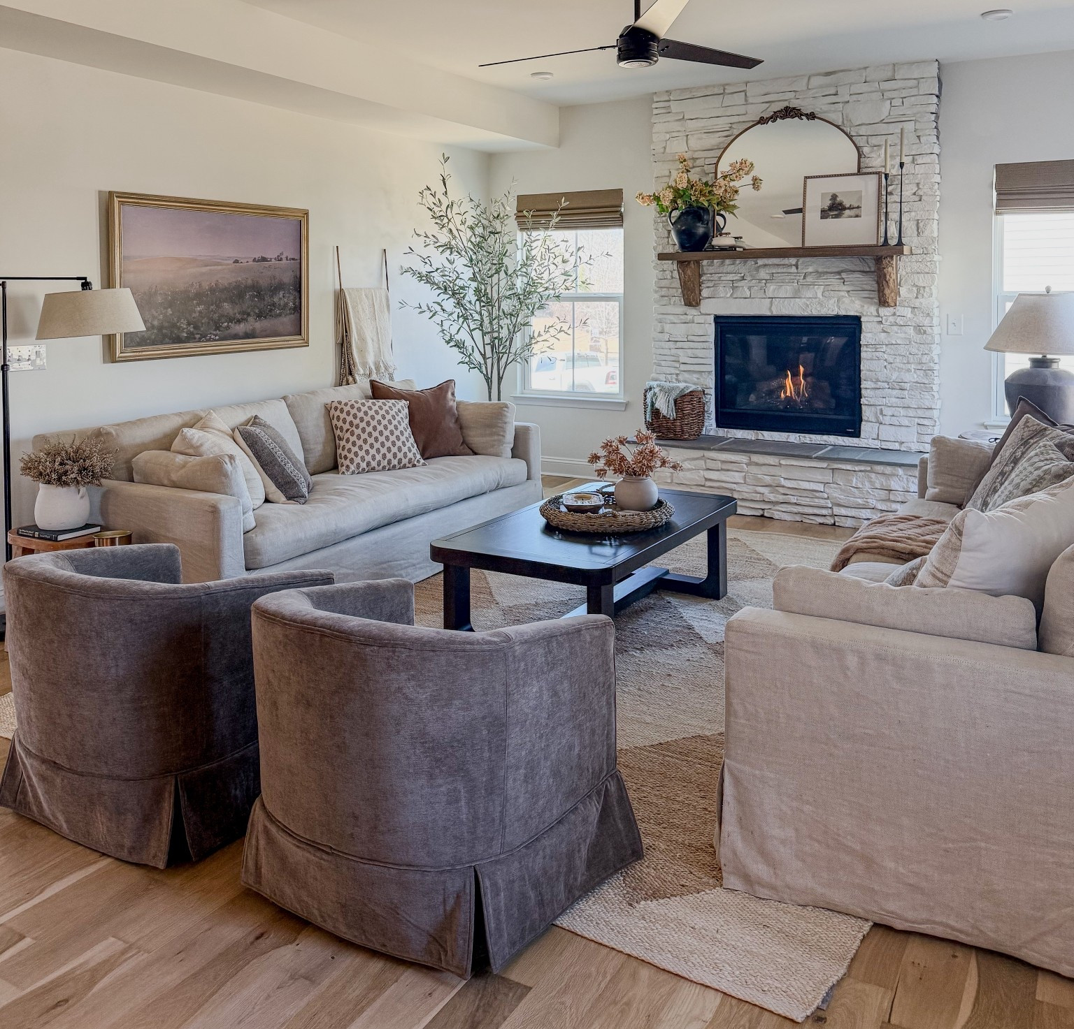 Added some warmth and interest to our living room with these brown swivel chairs 