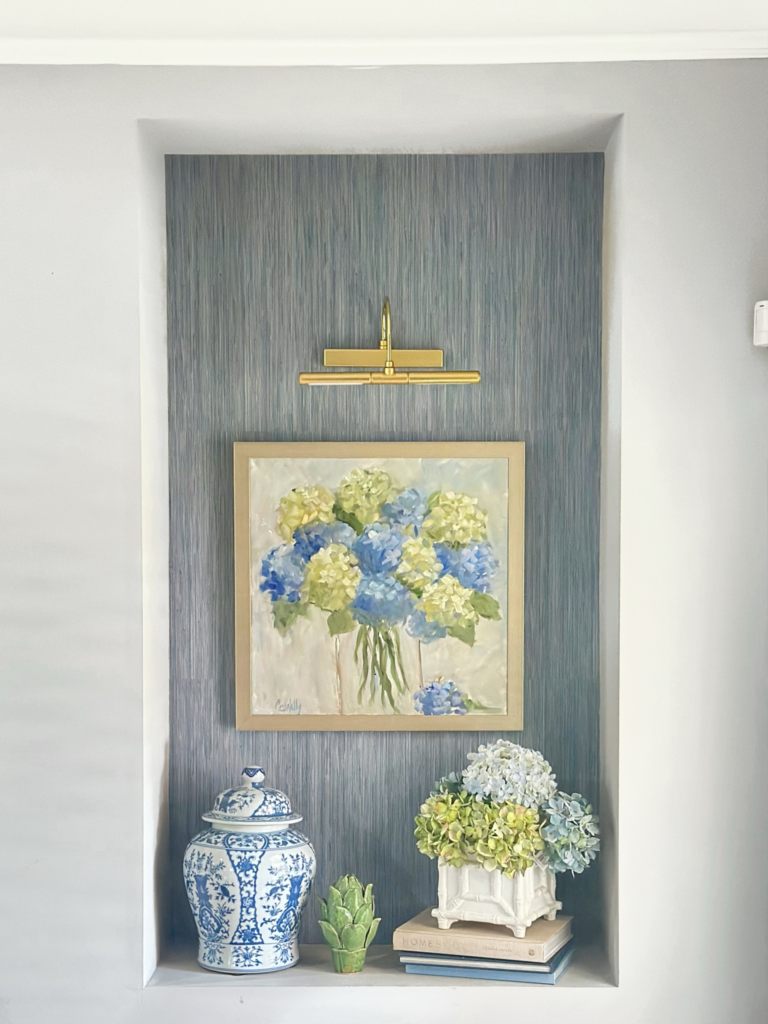 This little alcove off my kitchen has always felt a bit unfinished. I had my favorite blue and white pieces, some artwork I love, and fresh hydrangeas, but something was still missing. The space is deeper than it looks, and it just didn’t feel pulled together. I found this peel and stick grasscloth wallpaper on a whim and honestly didn’t expect much, but it completely changed the feel of the space. It took less than ten minutes to install and suddenly the whole area feels elevated, warm, and intentional. It’s one of those small updates that makes me smile every time I walk by. I linked everything in case you’ve got a little corner waiting for its moment too.

#LTKSeasonal #LTKHome #LTKWedding
