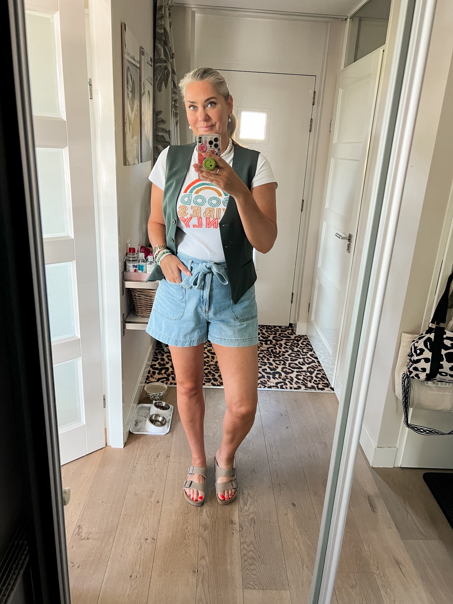 Ootd - Monday. Good Vibes only t-shirt paired with a bottle green gilet vest and a-line denim shorts. Birkenstock sandals. 

#LTKeurope #LTKnederlands #LTKspring