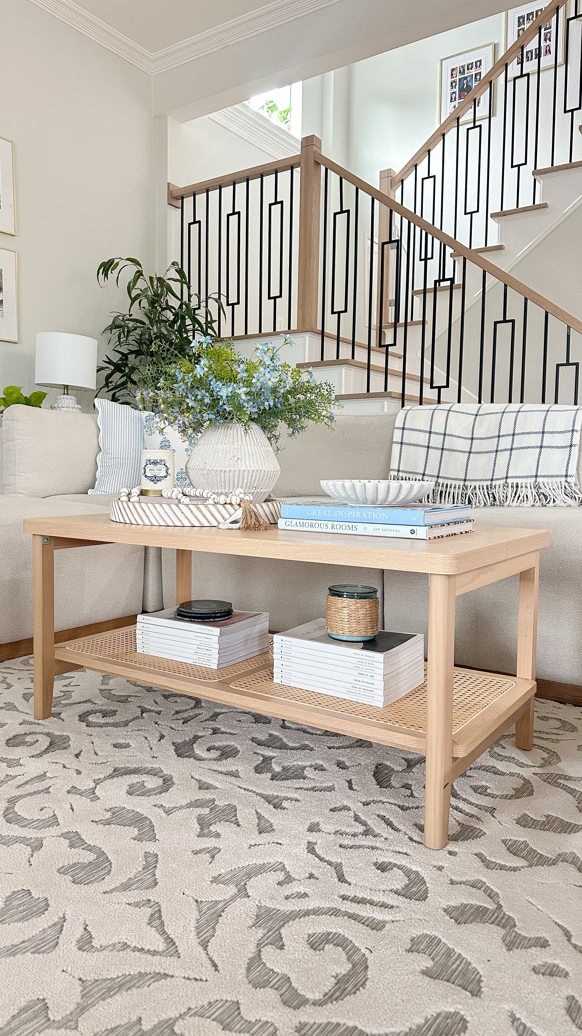 Fresh, light, and layered—this spring coffee table setup makes the whole room feel updated.
Here’s how I styled it with a mix of textures, faux florals, and a favorite scent:
	•	Ribbed ceramic vase
	•	Faux blue delphinium stems
	•	White and gold wood bead garland
	•	Carved wood + white tray
	•	Scented candle (Angel Food!)
	•	Coastal coffee table books
	•	Cane shelf coffee table
	•	Neutral patterned rug

Use these simple pieces to build your own spring moment that feels soft but pulled together.

#LTKHome #LTKSeasonal #LTKStyleTip #coffeetablestyling #springdecor #neutralhome #amazonhome #classiccoastal

#LTKStyleTip #LTKHome #LTKSeasonal