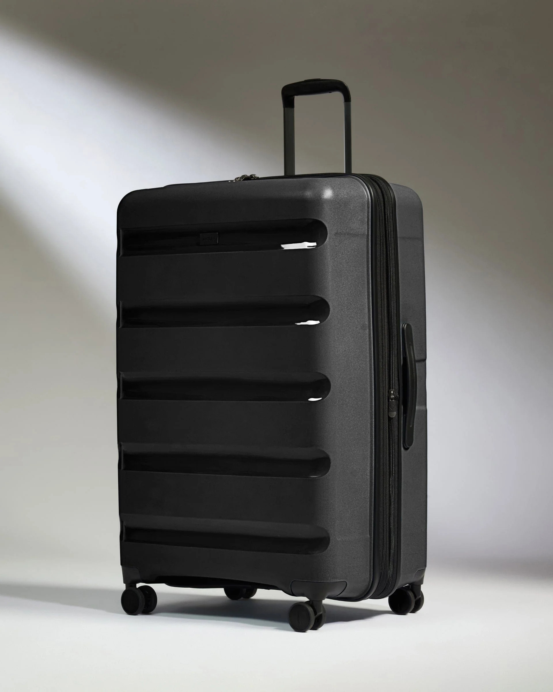 Large Suitcase Black - Logo Stripe | Lightweight Hard Shell Luggage | Antler UK