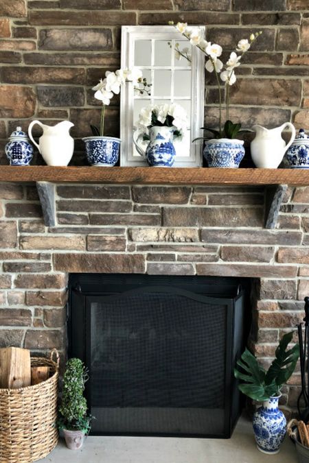Spring mantel decorating idea with blue and white porcelain, orchids and window pane mirror.

#LTKSeasonal #LTKstyletip #LTKhome