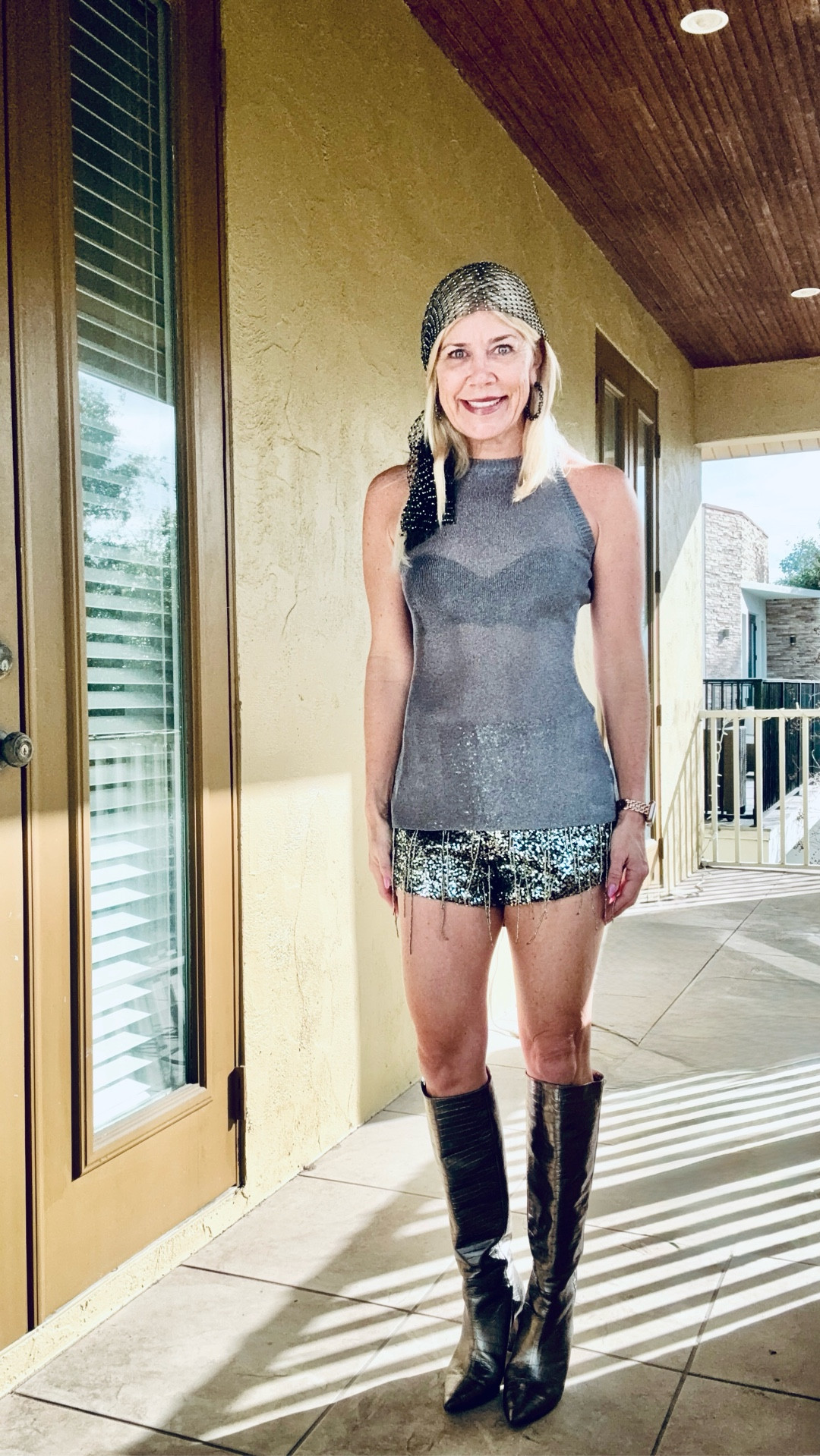 Gasparilla outfit 🏴‍☠️ Gunmetal metallic knit top, bead tassel embellished shorts with black satin back, Marc Ellis gunmetal boots (old), and a rhinestone black head scarf tied. Earrings are old (no brand). Shorts run small (wearing size 6, normally a 2-4). Top runs true to size or size fiendish small chested.

#LTKootd #LTKPetite #LTKOver40