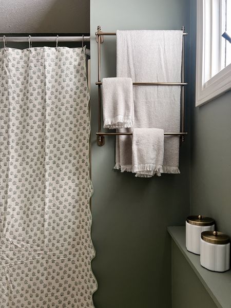 Loving this sweet moment in our bathroom update - we are making minor updates to hold us over before we do a full reno. I’m
Obsessed with this shower curtain and the brass towel holder and canisters! 

#LTKhome