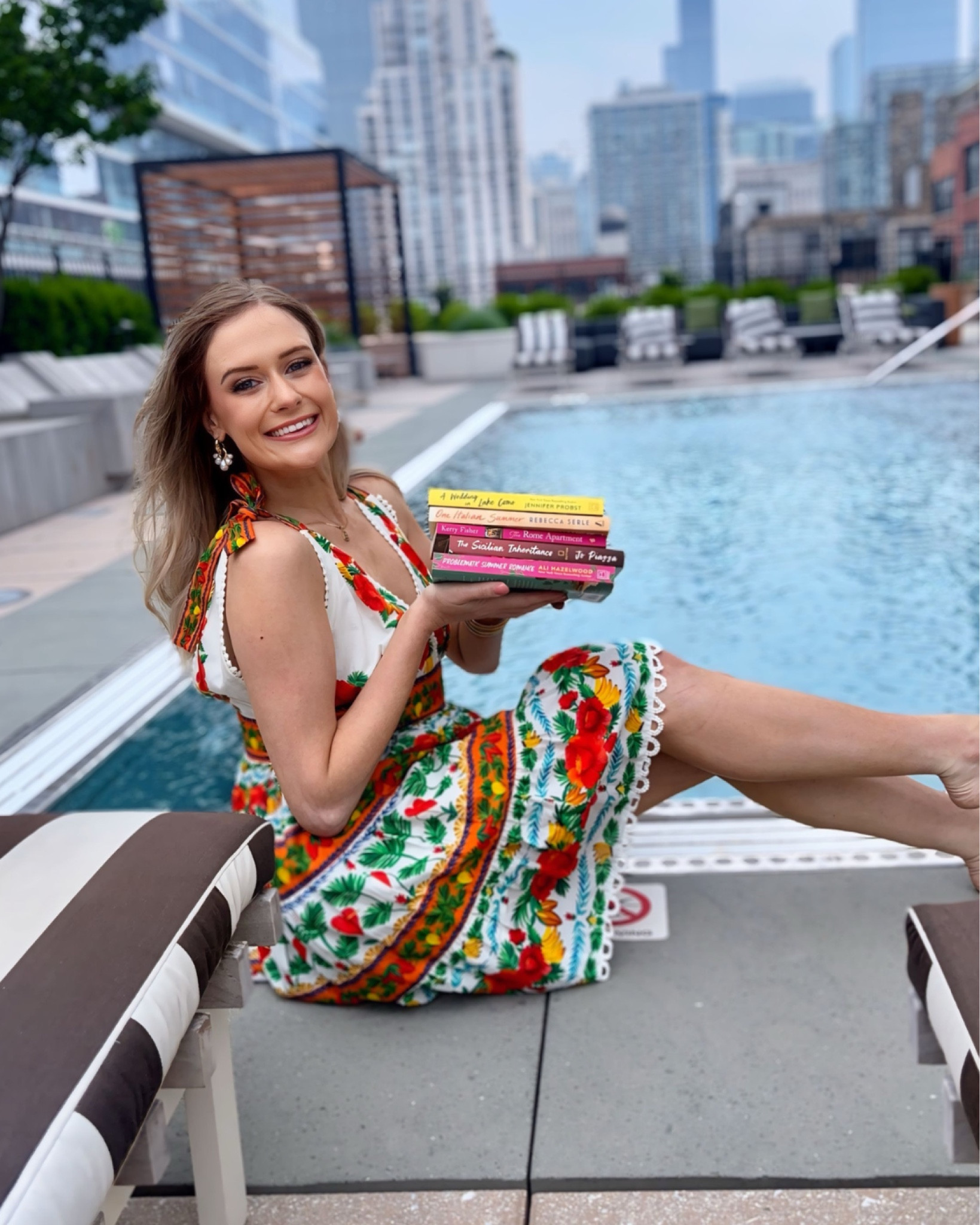 While everyone else is jet-setting across Europe, I’m taking a different kind of vacation—one that doesn’t require a passport, packed suitcase, or PTO request. This summer, I’m traveling through Italy one page at a time, with a stack of novels that whisk me from the Amalfi Coast to the hills of Tuscany, the romance of Lake Como to the secrets of Sicily. 