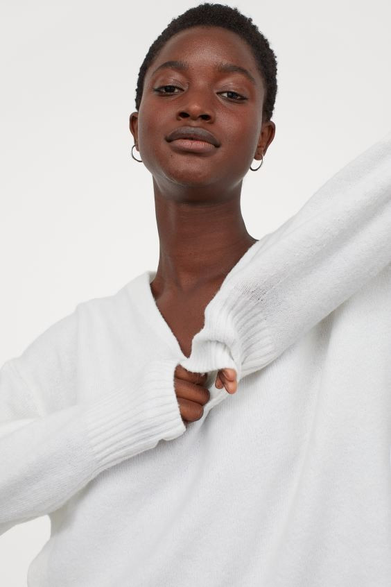 Wide-cut, knit sweater with wool content. V-neck, dropped shoulders, and long sleeves. Ribbing at... | H&M (US + CA)