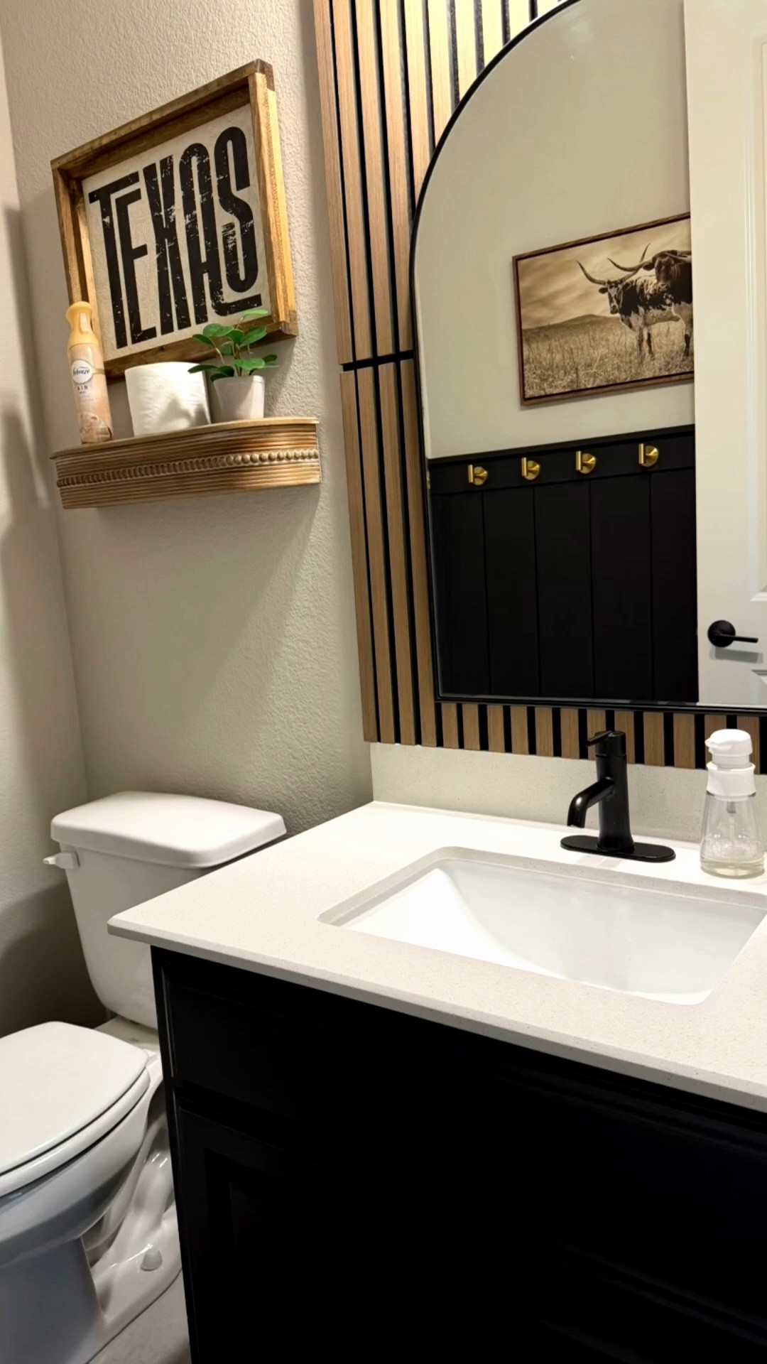 HALF BATH UPDATE
A few months back, I decided it was time to add some character to this half bath. 

The vision started about a year ago when I popped into HEB and fell in love with some of their western decor. 🤩

I wanted some PVC accents for the long wall so we can hang pool towels without worrying, because this bathroom is off of the back patio and easy access for our pool days/parties.

Ryan did great adding the accents and then graciously stripped and painted the cabinet this last week— a chore he swore he wasn’t going to do. When we got everything else together, though, he quickly commented that it’d look better with the black cabinet and therefore obliged. 

#Moodybathroom #bathroomupgrade #westerndecor #westernbatgroom #diybathroom

#LTKHome #LTKSeasonal