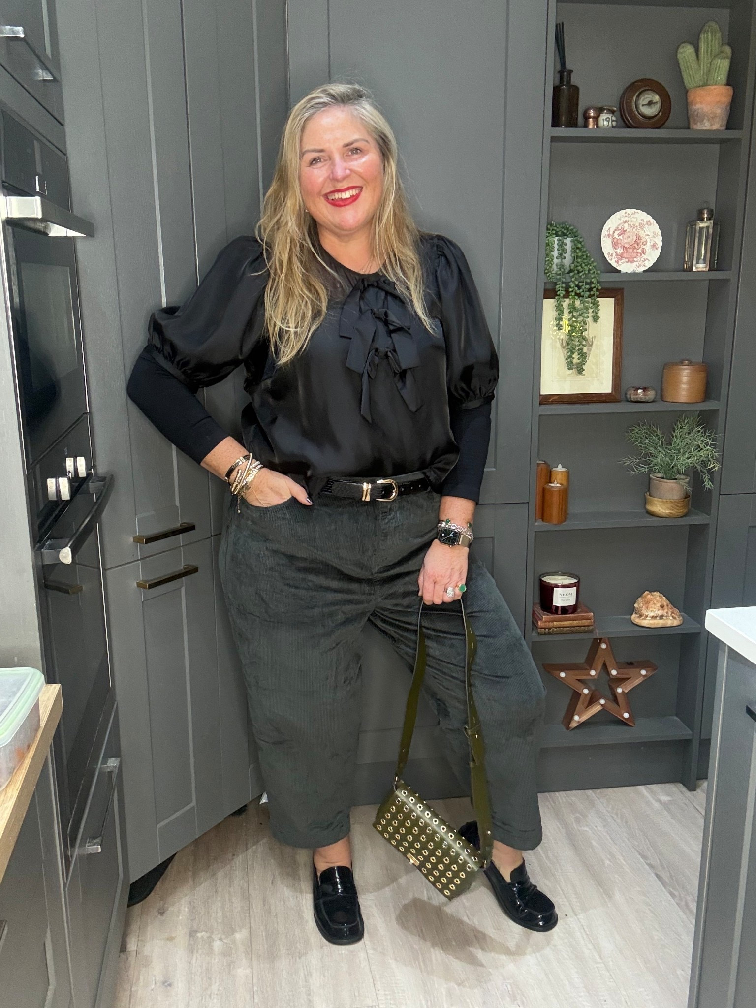 Black shaper tshirt, black sheer bow top, corduroy trousers, black loafers, green bag 

#LTKfestive #LTKplussize #LTKcurves