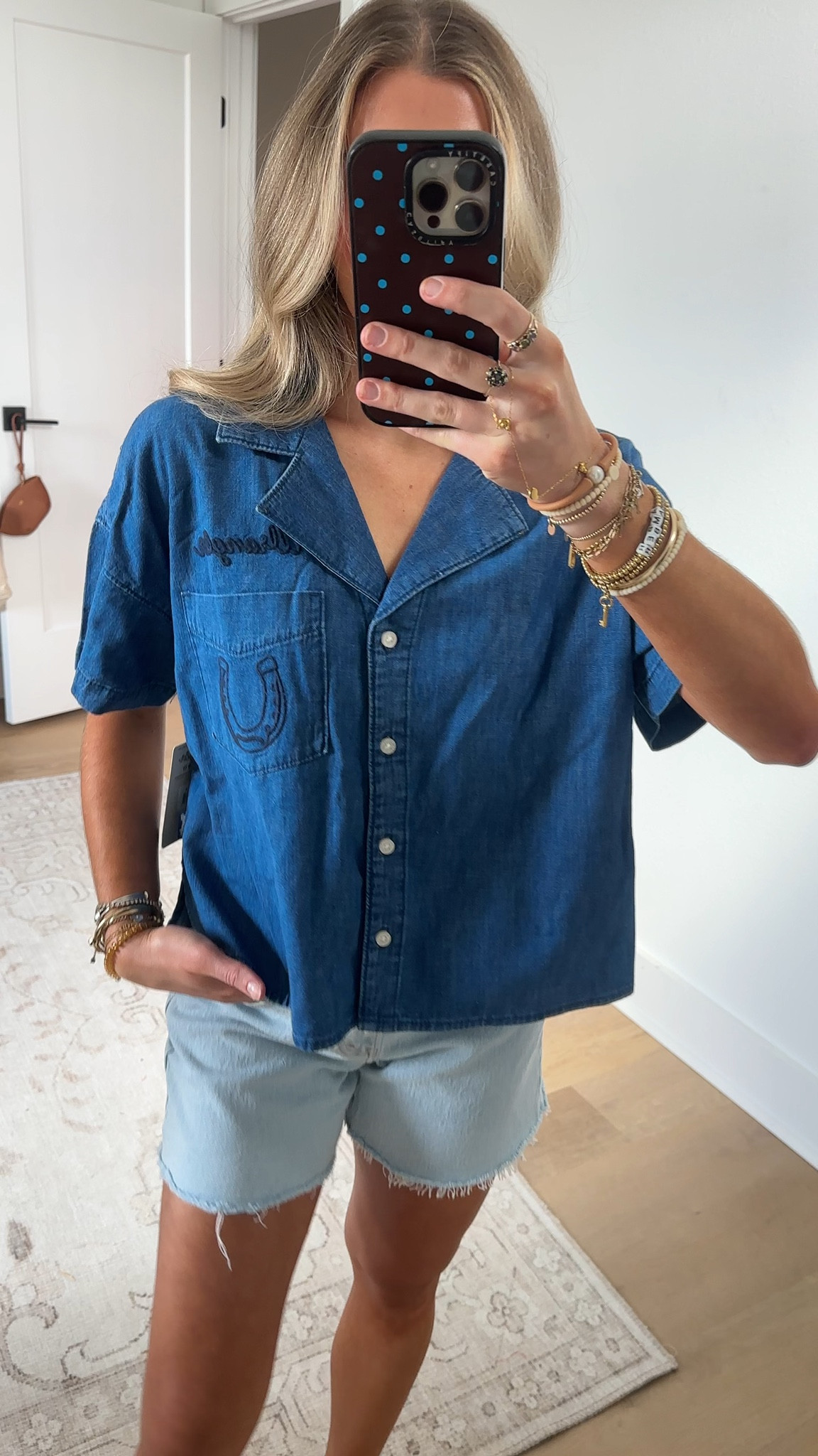 @Wrangler size small. Add a little good luck to every outfit with our Women’s Embroidered Denim Camp Shirt. Blending relaxed, everyday comfort with subtle Western charm, this short-sleeve shirt features delicately stitched horseshoe embroidery across the left chest pocket and a stitched version of the Wrangler® logo just above that for a touch of authenticity. Across the back, you get more embroidered artwork of a bronc rider in honor of the cowboys we love. Crafted from soft denim, this shirt drapes effortlessly and its camp-style silhouette keeps things classically laidback with a wink of Western spirit.

#LTKSeasonal #LTKootd #LTKFestival