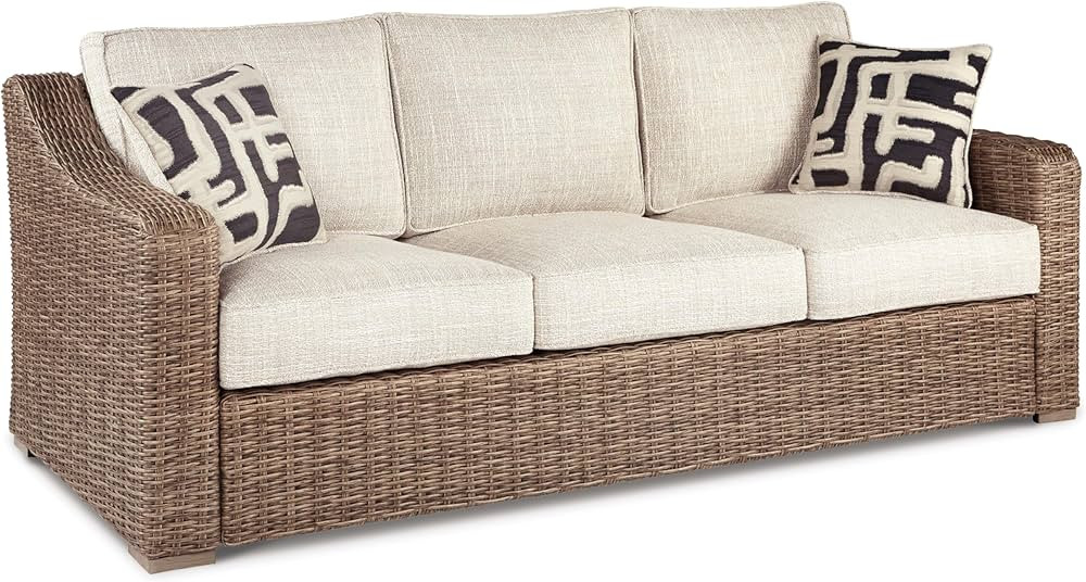 Signature Design by Ashley Beachcroft Outdoor Wicker Patio Sofa with Cushion and 2 Pillows, Beige | Amazon (US)
