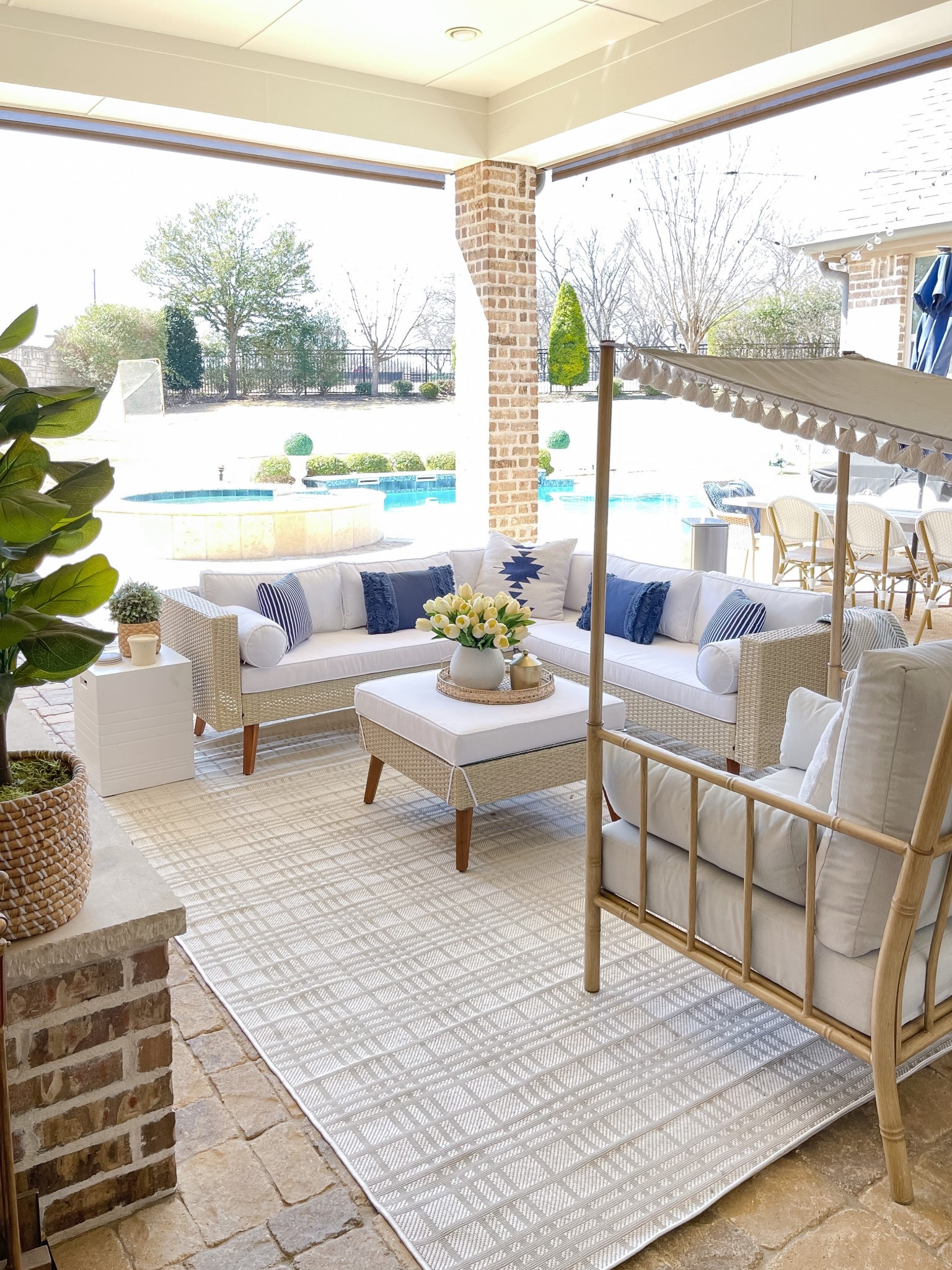 Safavieh sectional, gray and white grid rug, blue and white patio. 