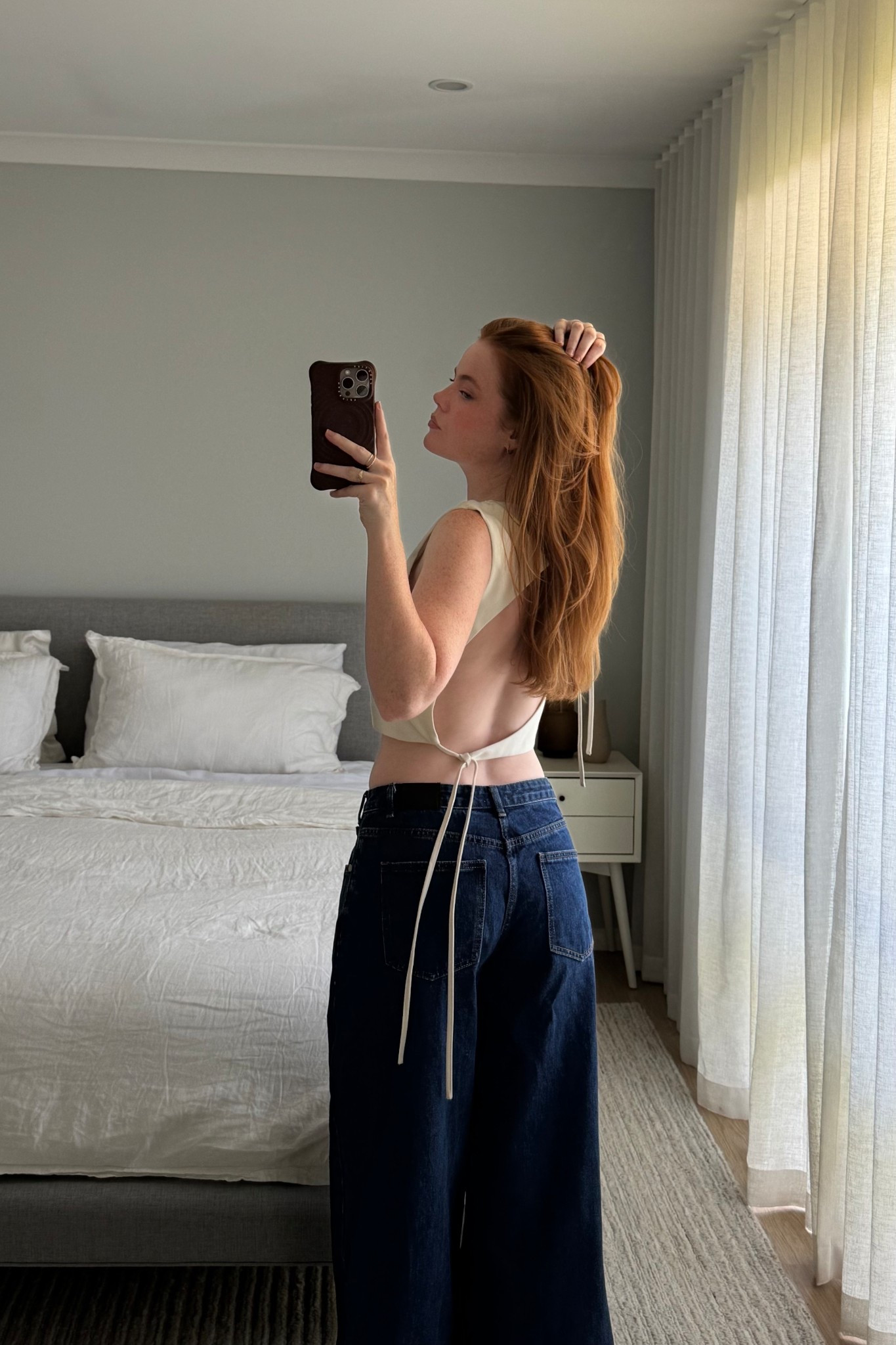 A backless white top and a pair of low rise wide leg jeans – a simple but definitely not boring OOTD.

#LTKaustralia #LTKjeans #LTKsummer