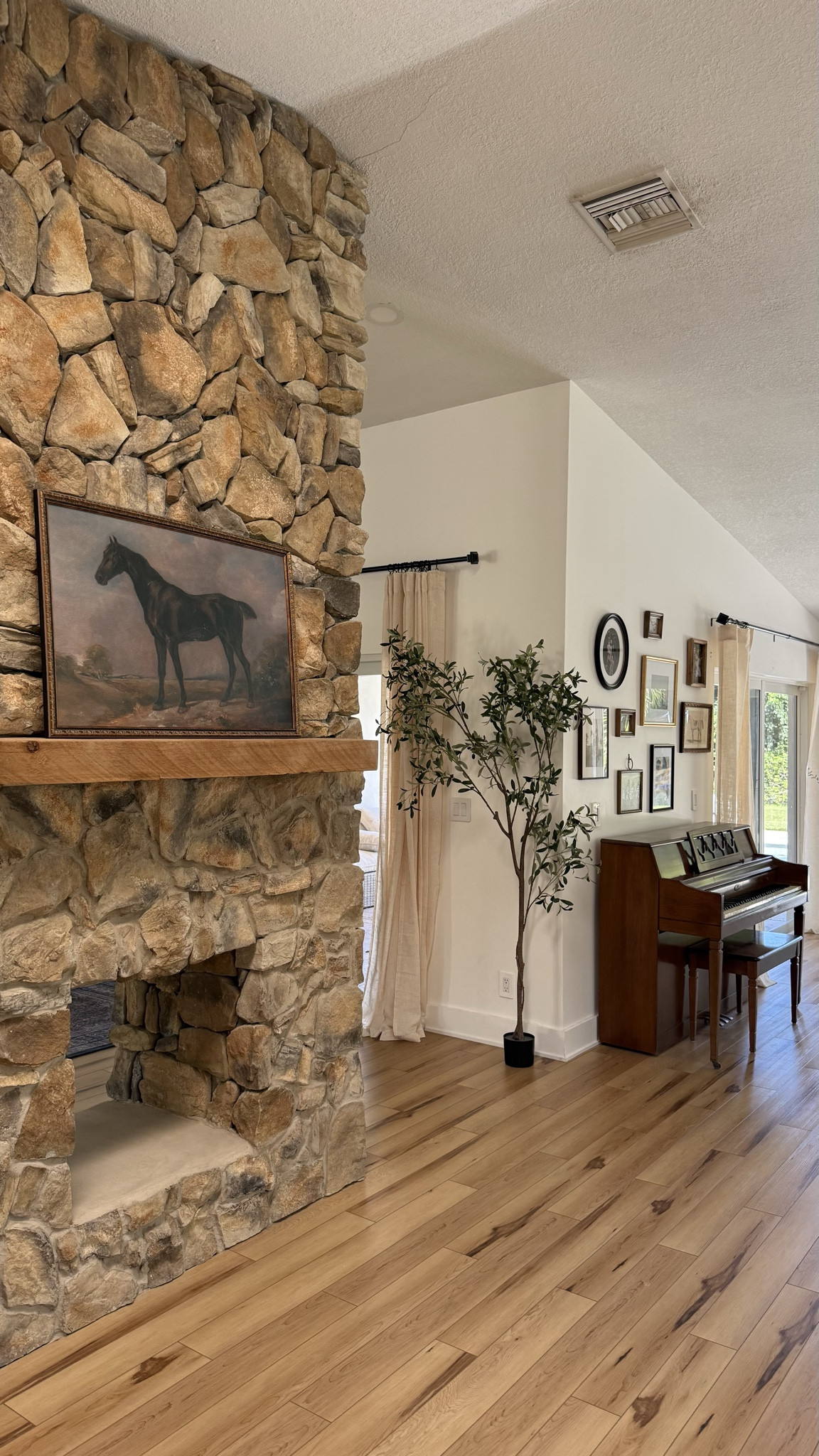 Our living room feels so warm and timeless lately the mix of stone, wood tones, and vintage art just works 🤎 I’m loving how the classic horse painting ties in with the piano and gallery wall for that collected, cozy feel. A little moody, a little traditional, and so homey

               vintage home decor, moody traditional living room, timeless home style, stone fireplace decor, vintage art Target finds, warm neutral home decor, classic interior design aesthetic 

 #HomeDecor #TraditionalHome #VintageStyle #CozyHome #NeutralDecor #TimelessDesign #InteriorInspo #LTKHome #HomeAesthetic #VintageArt #WarmInteriors #ClassicHomeStyle #MoodyHomeDecor #ThresholdByStudioMcGee #TargetHome #LTKHome #LTKSaleAlert #LTKFamily