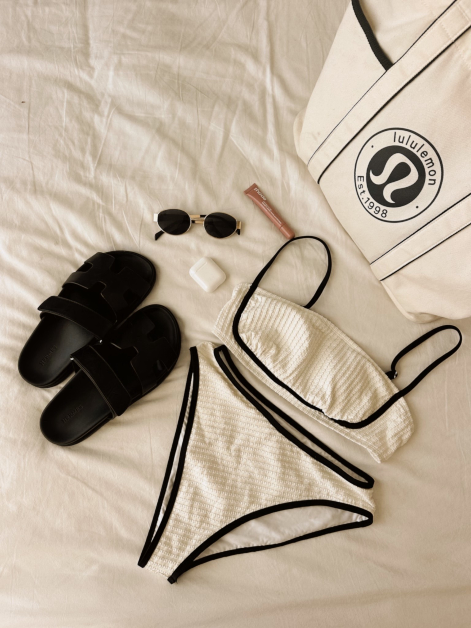 Effortlessly chic for those warmer days ahead! 🤍🖤 My go-to minimal look for lounging, with a pop of color. These oval sunnies and those comfy sandals (such a good quality luxe on a budget find) are a must.

#ChicStyle #MinimalFashion #SummerOutfit #SwimStyle #LululemonTote #HermesDupe #FashionFinds

#LTKSwim #LTKShoeCrush #LTKFindsUnder50