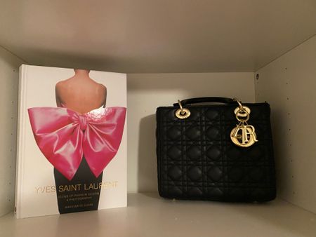 beauty room Home decor inspiration. YSL coffee table book from Amazon on sale now! Designer inspired bag under $50. Dior lady bag. Dior aesthetic. Pinterest inspired decor. Soft girl aesthetic. Parisian inspired. 

#LTKitbag #LTKhome #LTKFind