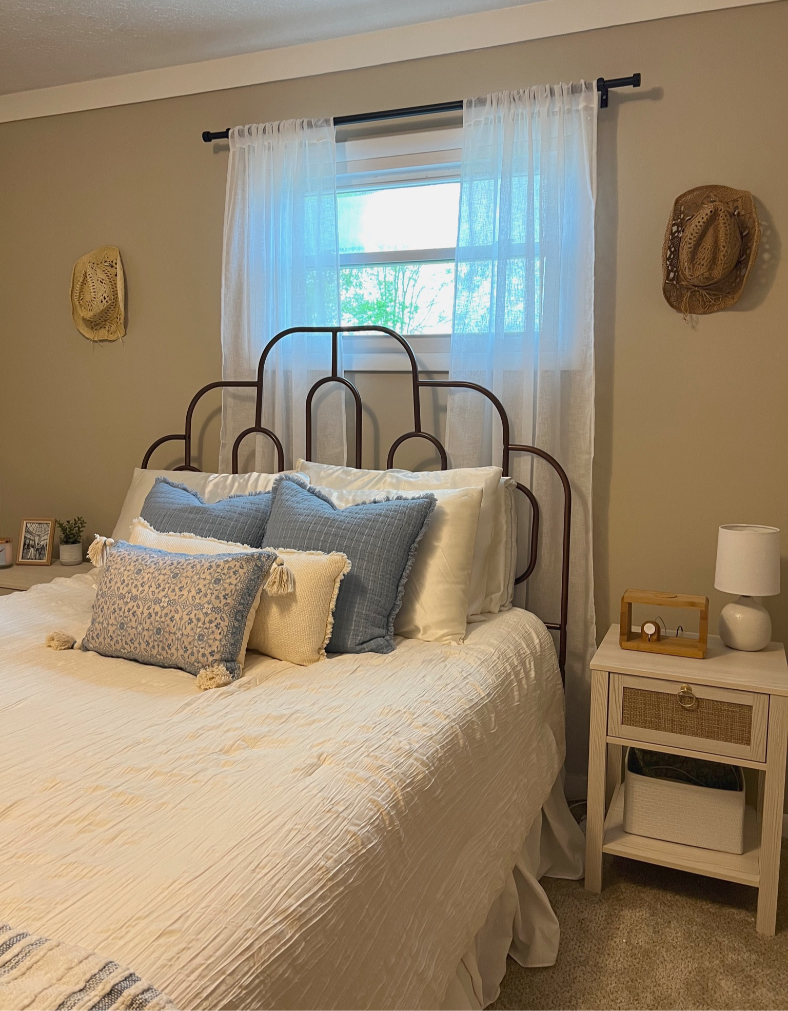 costal inspired bedroom 🐚

I incorporated washed wood, coordinating nightstands with rattan detailing, retro bed frame, white textured comforter, blue throw pillows with texture and pattern & cowgirl hats as wall decor 

costal cowgirl bedroom, costal room decor, room decor, surfer girl aesthetic, bedroom decor 

#LTKhome #LTKstyletip #LTKfamily
