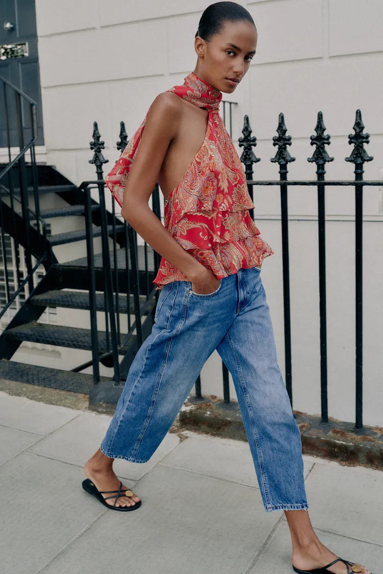 Halter neck top featuring a tie detail and open back. Front ruffle details. Lined. Back hidden bu... | Zara US