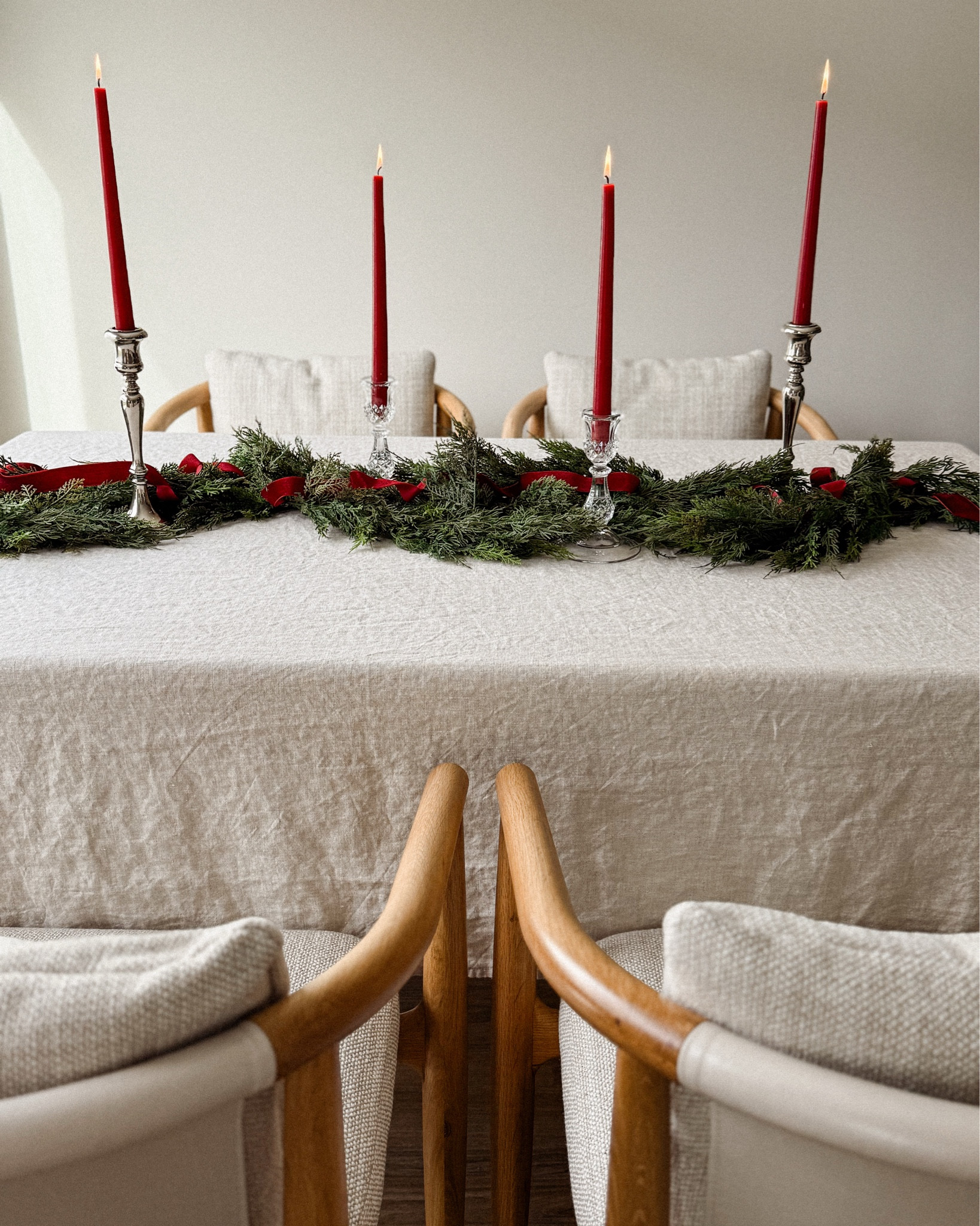 there’s something about a simple holiday table that feels like its own little love letter to the season ♥️ lush cedar, deep red tapers, and that soft afternoon light that only december can give. this garland from @christmas_central instantly made the whole room feel warmer, greener, more alive.

i wove velvet ribbon through the branches, set out my crystal candlesticks, and suddenly the simplest things like dinner with the people you love or a slow evening at home felt special again. sometimes all a table needs is a little greenery to become a memory.

#ad #ChristmasCentral #ChristmasCentralFinds #Northlight

#LTKSeasonal #LTKHome #LTKHoliday