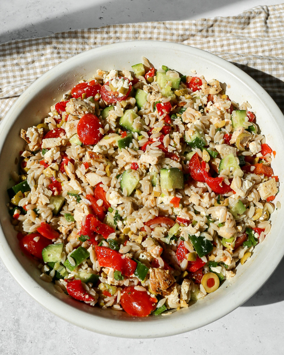 Making this Mediterranean Chicken Orzo Salad with all of my favorite kitchen tools and everything is linked! 🫒🍋 The OXO Good Grips Mixing Bowl Set is perfect for whisking together the homemade lemon dressing and tossing all of the ingredients together before transferring to the serving bowl. The OXO Good Grips Wooden Utensil Set is what I reach for to stir and toss everything together and I use these constantly in my kitchen. The stainless steel measuring spoon set is essential for getting the dressing proportions just right. The Anchor Hocking 8 oz measuring cup is my go to for measuring liquids and the mini whisk is perfect for whisking the dressing together quickly and easily. The large white and black serving bowls are absolutely beautiful for presenting this salad and are the perfect size for a big batch. And the reusable bowl covers are so handy for covering the salad while it chills in the refrigerator.  Full recipe is on the blog and everything is linked here! 🔗 

 #LTKdayinmylife #LTKfoodie #LTKHome