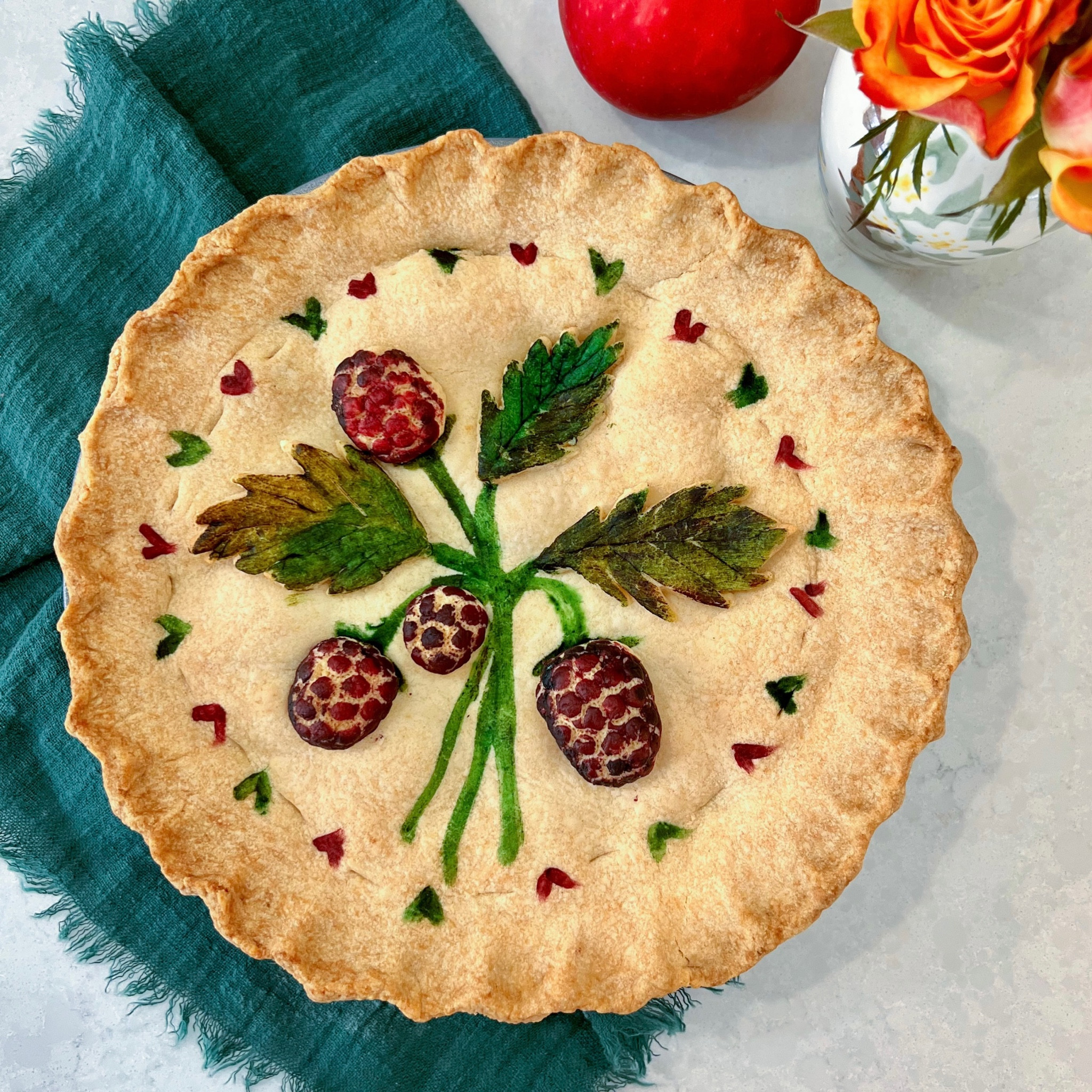 🎨🍏 a pastry canvas for a prettier pie! 

I want to show how to make an Apple and Blackberry Painted Pie and turn something quite ordinary into a work of edible art! You don’t need any fancy equipment just a few shades of food colouring and a bit of creativity! 

If you want to give it a go, you will need: 

Pastry:
• 200g cold unsalted butter
• 400g plain flour
• Pinch of salt
• 2 tbsp caster sugar
• 2 egg yolks
• 4-5 tbsp cold water
• Food colouring (I can bring)
 
Filling:
• 6 Granny Smith apples
• 75ml water
• 60g soft brown sugar
• 125g blackberries
• 2 tbsp caster sugar
• 1 tbsp cornflour
 
Method:
 
1. For the pastry, blitz the flour, sugar, butter and salt in a food processor, or rub together by hand.
2. Add in the egg yolks and water a tbsp at a time until it comes together into a dough. Roll out to around half a cm thick. 
3. Grease an 8 inch pie tin, and using your fingers to work it to the edges, line the tin with the pastry, trimming around the outside. 
4. For the filling, peel, core and chop the apples into chunks, and cook in a pan with the water and brown sugar until they are tender.
5. Let them cool, then toss in a bowl with the blackberries, caster sugar and cornflour.
6. Place the filling on top of the pastry in the pie dish, and cover with another disc of pastry, using your hands or a fork to crimp the edges together. 
7. With any leftover pastry, create your design, and make sure to use a knife to prick a few holes to allow any steam to escape. 
8. Use food colourings to add colour and decorate your pie.
9. Bake at 180°C for around 30 minutes, until the pastry is a lovely deep golden brown. 