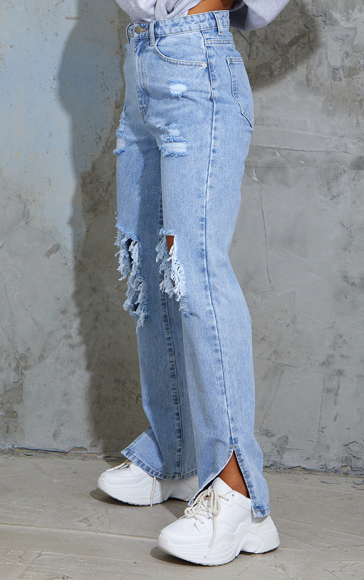 Light Blue Wash Ripped Open Knee Split Hem Jeans | PrettyLittleThing UK