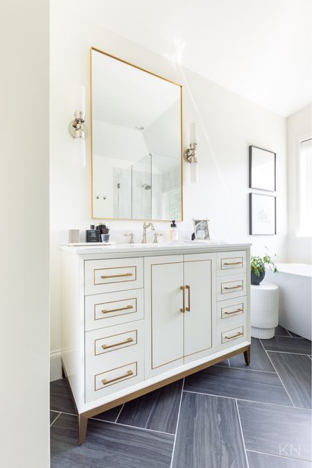 Bathroom clutter is kept to a minimum since we have two of these white vanities with excellent cabinet and drawer storage space. home decor bathroom decor white vanity bathroom art freestanding tub nickel sconce brass mirror

#LTKstyletip #LTKhome