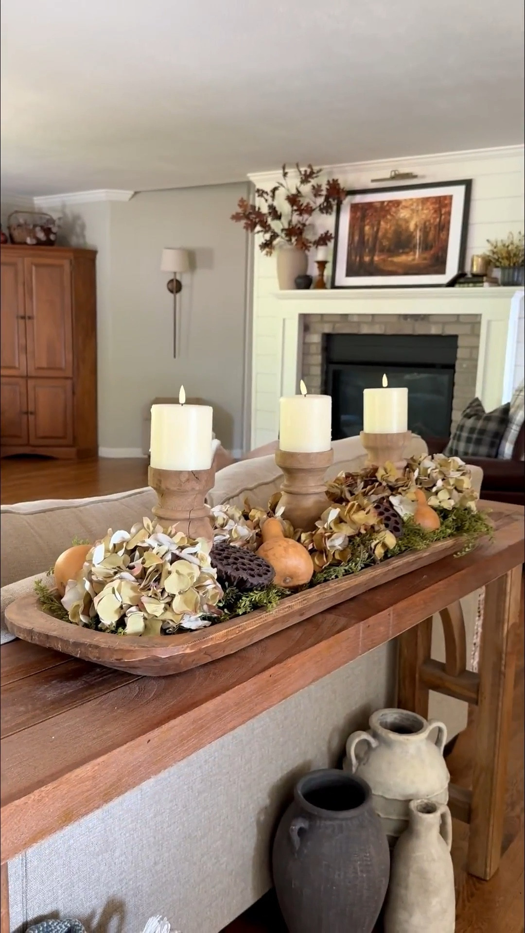 A long tray makes the perfect base for a layered fall centerpiece. 🍂 I started with a vine garland for movement, then added three vintage-style wood pillar candle holders with rechargeable candles for that cozy glow. From there, I tucked in fall-inspired hydrangea heads, dried gourds, and lotus pods to bring in texture and natural charm. The result is a timeless double-bowl centerpiece that feels collected, warm, and perfectly autumn. ✨


#LTKSeasonal #LTKHome