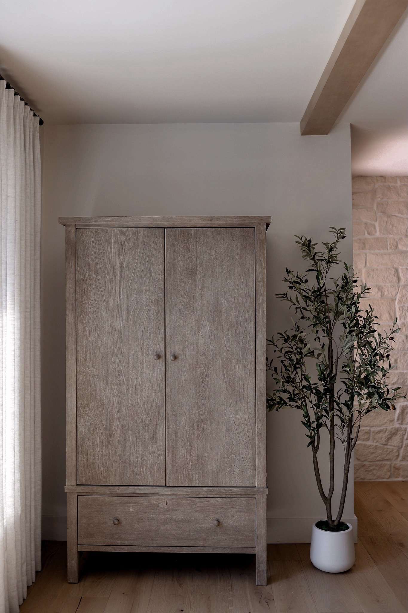 Pinch pleat curtains, faux olive tree, and my favorite armoire 🤍
