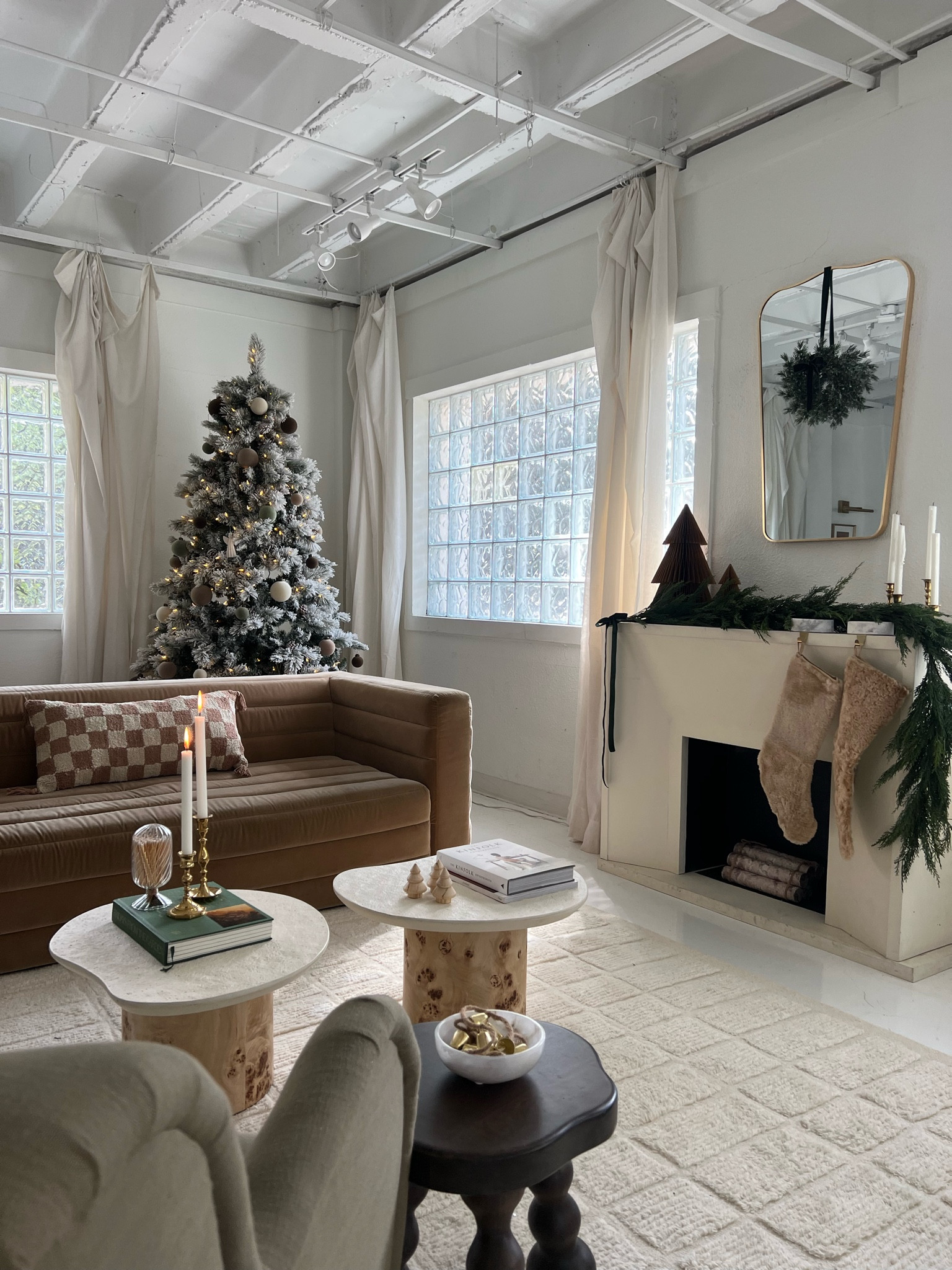 Christmas decor: holiday living room home decor: garland, wreath, stool, green accent chair, camel color sofa, checkered pillow, mini wreath, Christmas stocking 

#LTKparties #LTKhome #LTKHoliday