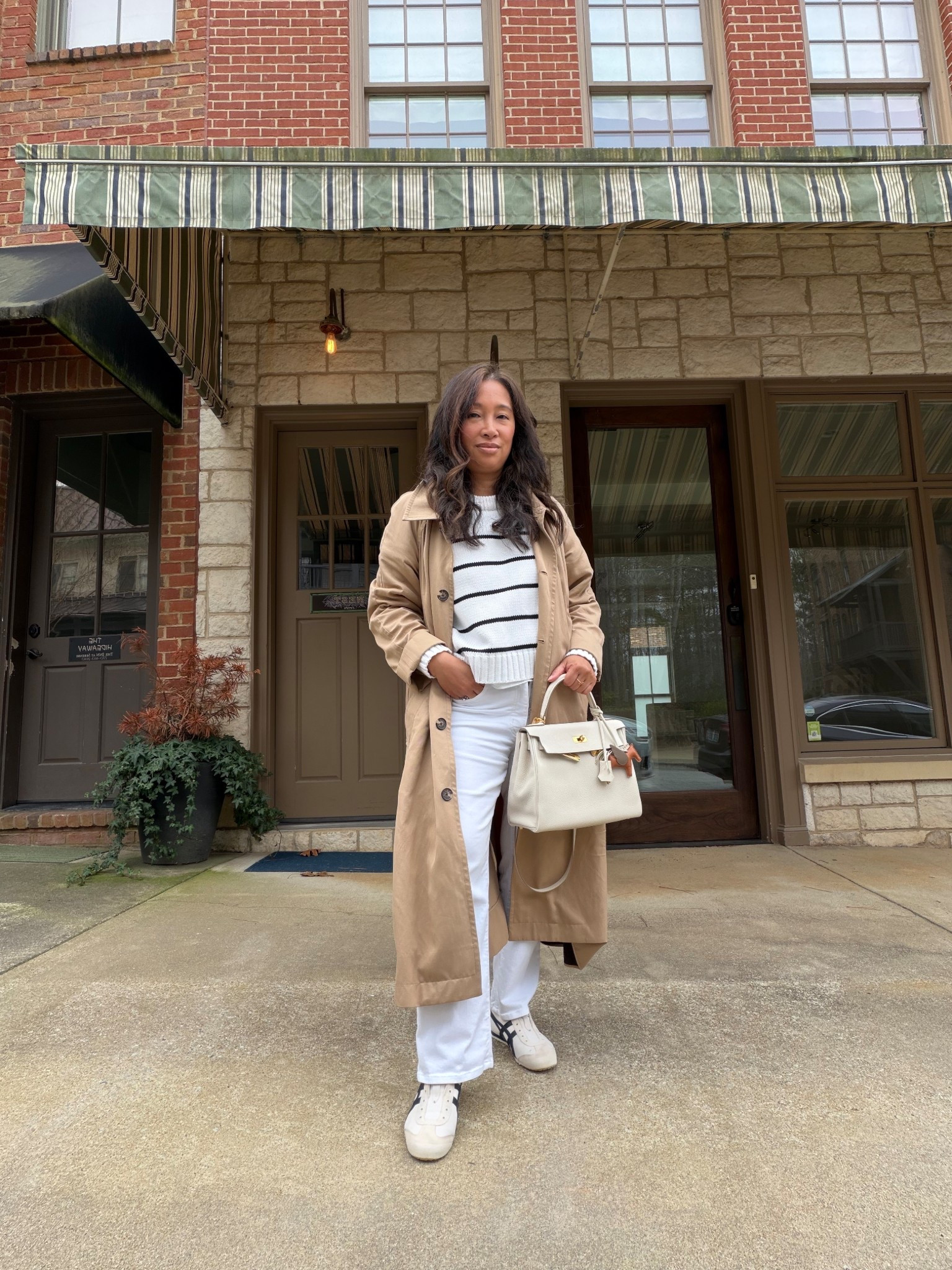 Simple spring outfit 
Trench 
Striped Sweater
White Denim
Navy and White Sneakers