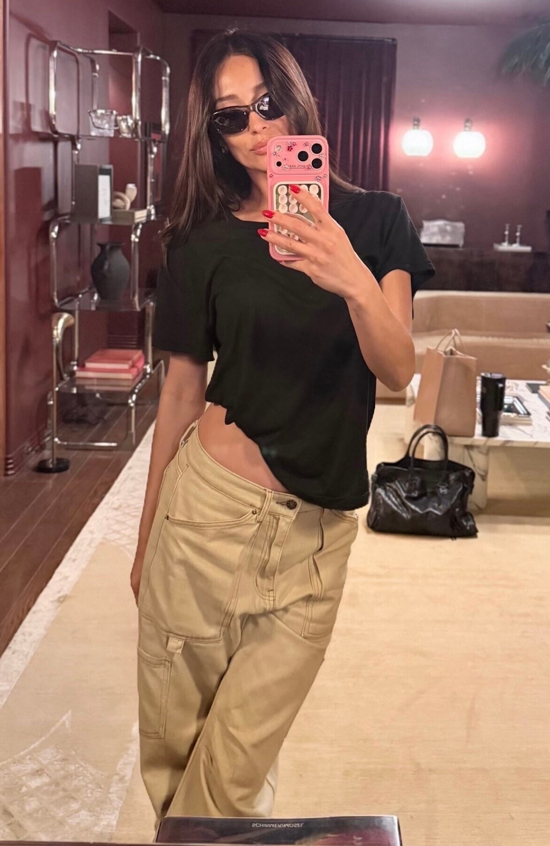 Shay Mitchell's tan Pant bring an effortless attitude with a throwback edge. Designed to sit low on the hips, this pair delivers that perfectly undone silhouette. Cut in a relaxed, baggy fit, they sit just right. This carpenter-style jean is elevated with functional side pockets and subtle darts at the knee, adding shape and dimension to the laid-back fit.
