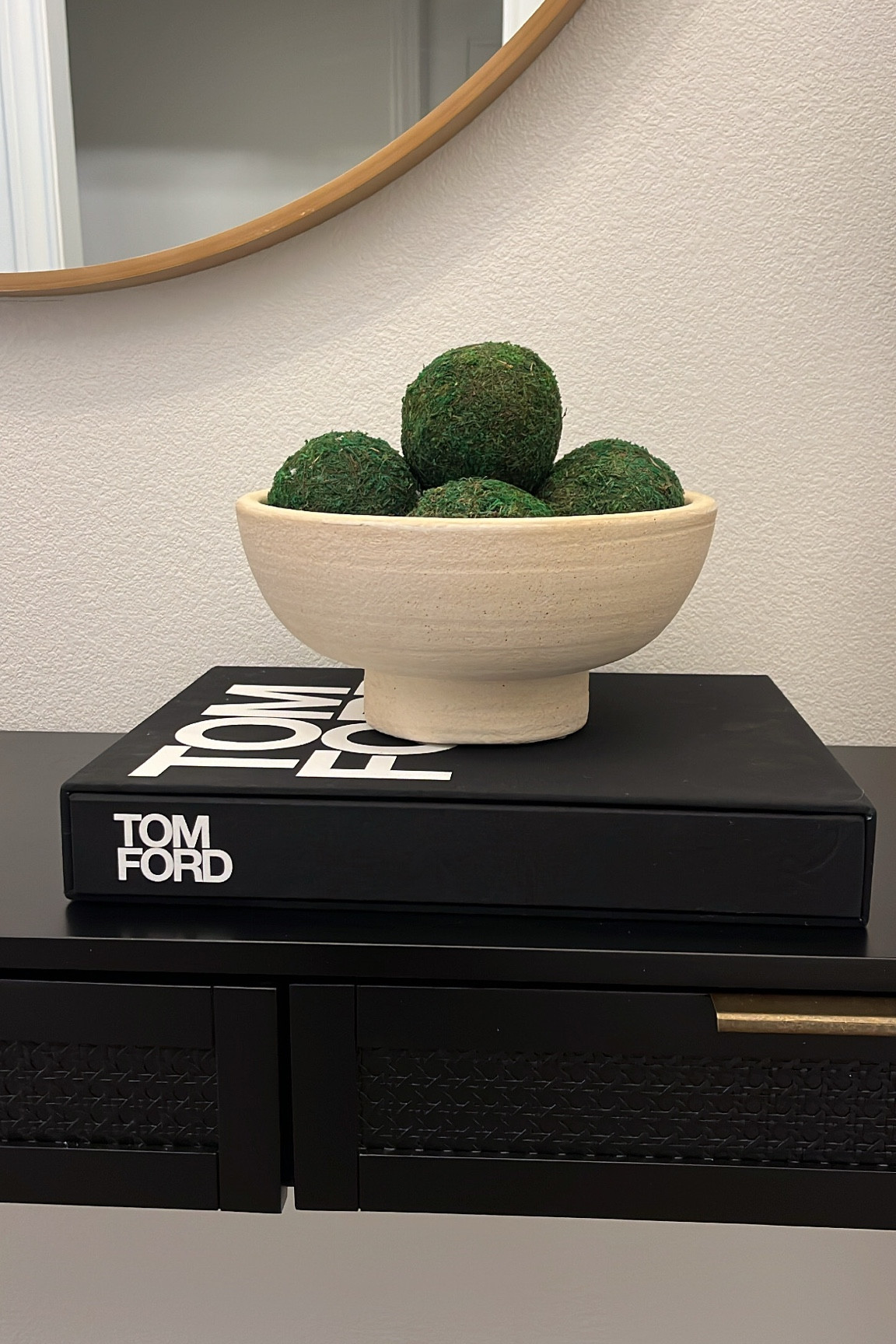 Entry way table decor. Decorative bowl - target. Moss balls - amazon. Decorative book - home goods. The Tom Ford book is on sale! 

#LTKunder100 #LTKsalealert #LTKhome