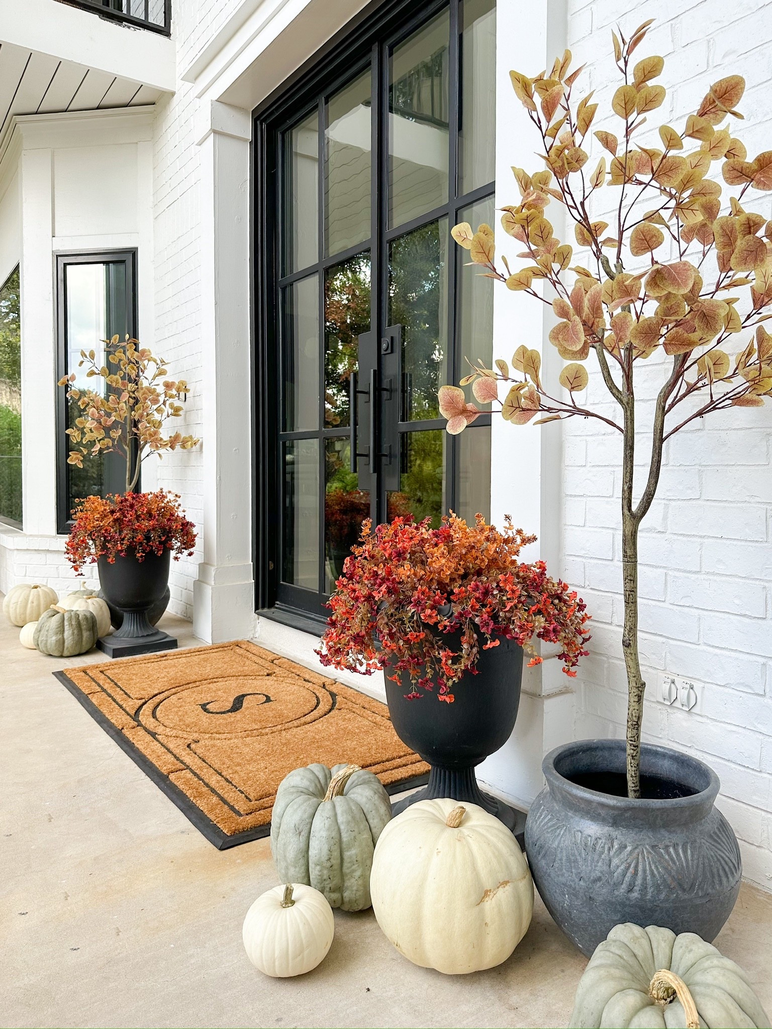 Fall faux front porch! For each planter, I used (2) 2 packs of the hanging mums in Orange Brown, and split the (1) 12 pack of Dark Brown eucalyptus between the 2 planters.

#LTKHome #LTKStyleTip #LTKFindsUnder100