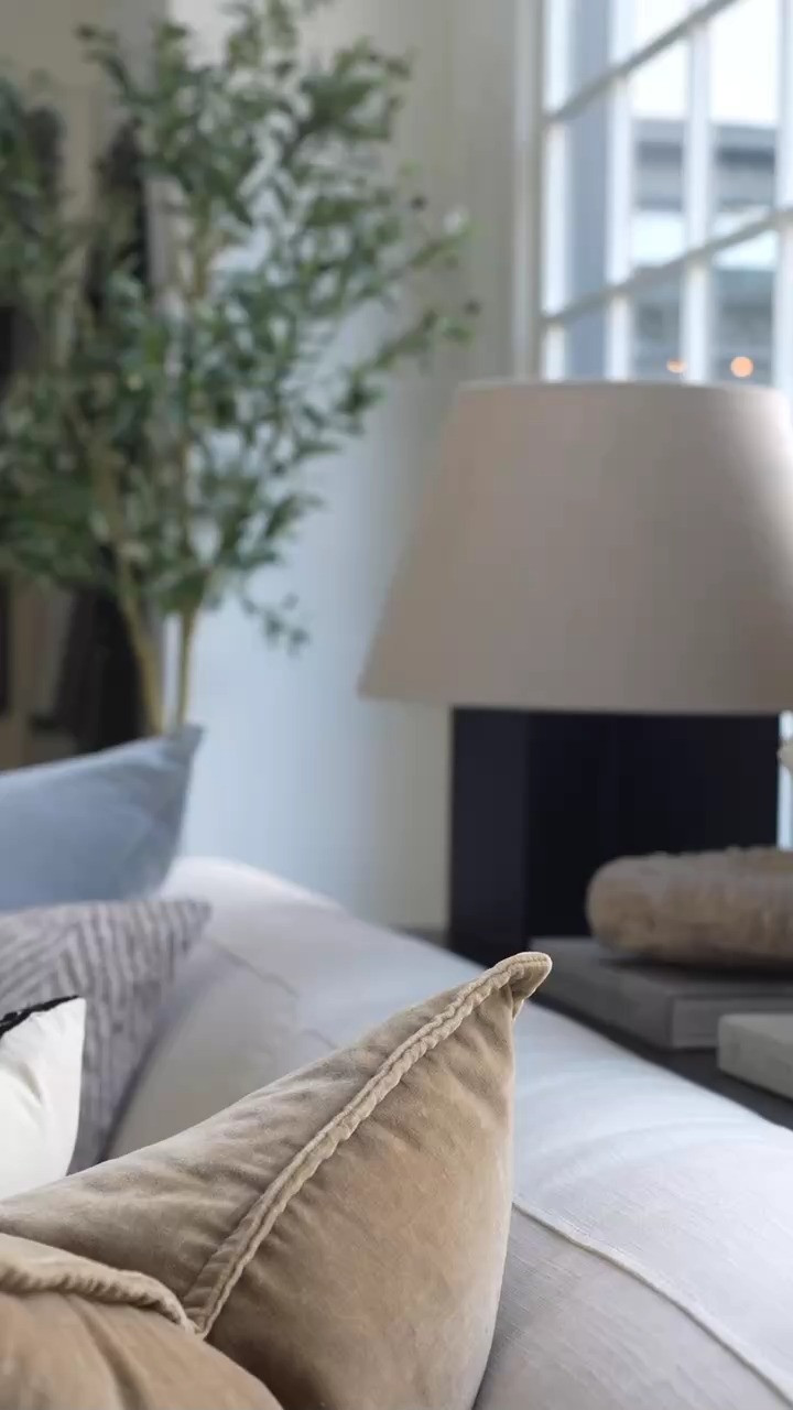 EEP I am loving this cozy spring moment. Sitting on the couch with a book while the candle glows and those beautiful blue accents add the sweetest pop of color to the coffee table styling. The mix of neutral decor, classic blue and white ceramics, and layered design books makes the living room feel fresh, calm, and perfectly styled for spring.  

 #LTKdayinmylife #LTKSeasonal #LTKHome