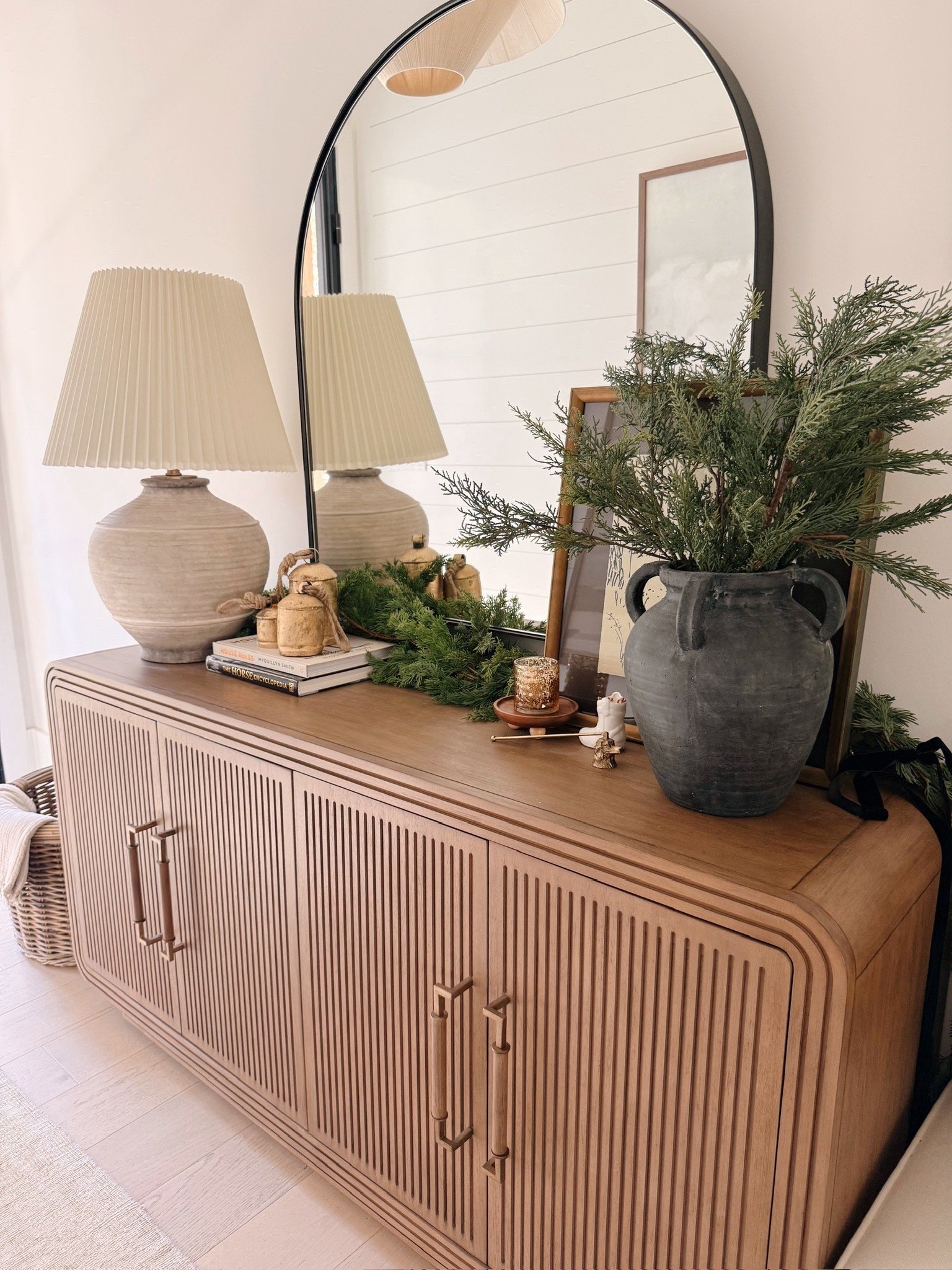 ✨ Want your home to feel instantly elevated with the simplest holiday touches?
The ribbed console, organic pottery, natural cedar greens, brass bells, sculptural lamp base, and arched mirror combine to create a warm, refined Modern Classic entryway that feels festive without overwhelming the space.

#porcheandco #holidaydecorideas #modernclassicstyle #entrywayvignette #greeneryandbells #organicdecorstyle #neutralentrywaydesign #holidayconsoleinspo #archedmirrordecor #warmseasonalstyling

Do you want to bring our dreamy Modern Classic style interior design into your own home? 🏡 You’re in luck! Reserve our Online Interior Design packages today -> https://porcheandco.com/edesign ✨ We can’t wait to work with you & design your home with #porcheandco


#LTKHome #LTKSeasonal #LTKHoliday