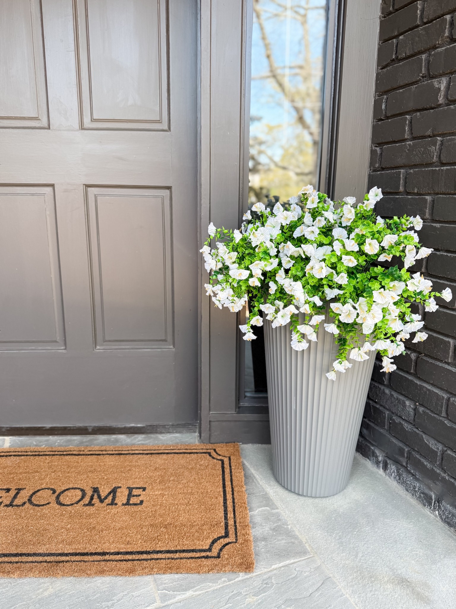 Spring Must Have! I can’t believe that these morning glories are fake! I was on the hunt for the perfect faux florals to pair with these awesome planters from Amazon, and stumbled across these. I used a floral foam ball to hold the stems together in the planter and love the way that it turned out! They look so beautiful and will last all season!

#fauxflorals #outdoorfauxplants #planterpots #frontporchmakeover #springentryway