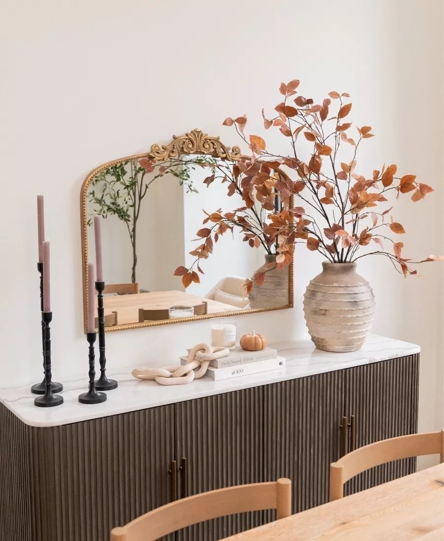 This console table from our previous home still has my heart! The statement branches, the rustic vase, the black candle holders — I am still so obsessed with every detail. Also linked the sideboard and gold mirror that you all love!

fall refresh, fall home decor, Arhaus, sideboard, wall mirror, Pottery Barn, faux branches, taper candles, terracotta vase, entryway styling