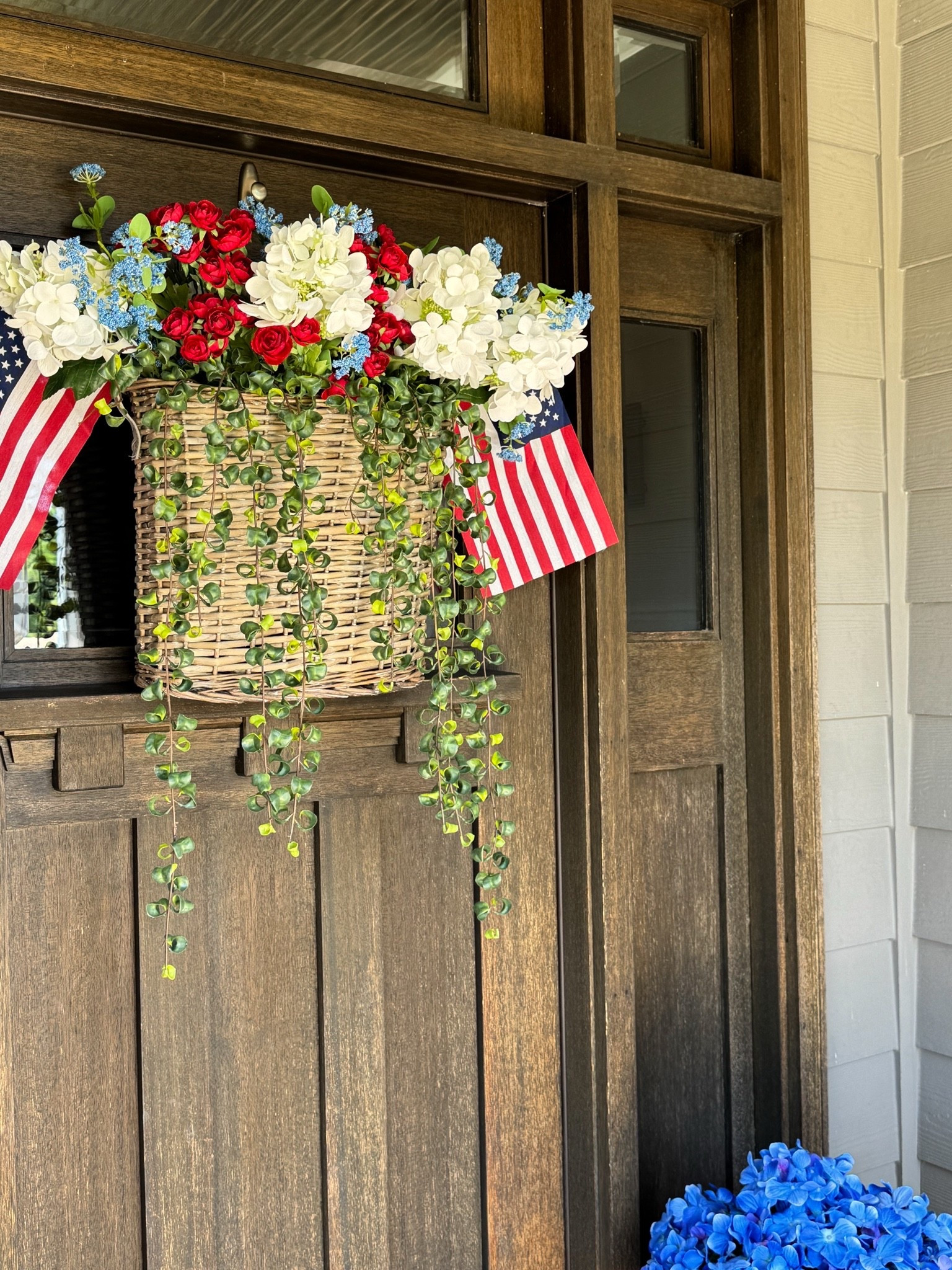 Patriotic Door Basket!! What a great way to celebrate America’s 250th Birthday♥️🤍💙
This arrangement just screams summer and can be used for Memorial Day & 4th of July.
Michaels has really stepped it up with their real touch florals!!

Real touch florals, hydrangeas, Queen Anne's lace, mini Ranunculus, UV greenery, hanging curly ficus, 8x12 American flags, hanging baskets

#LTKHome #LTKSeasonal #LTKstorytime