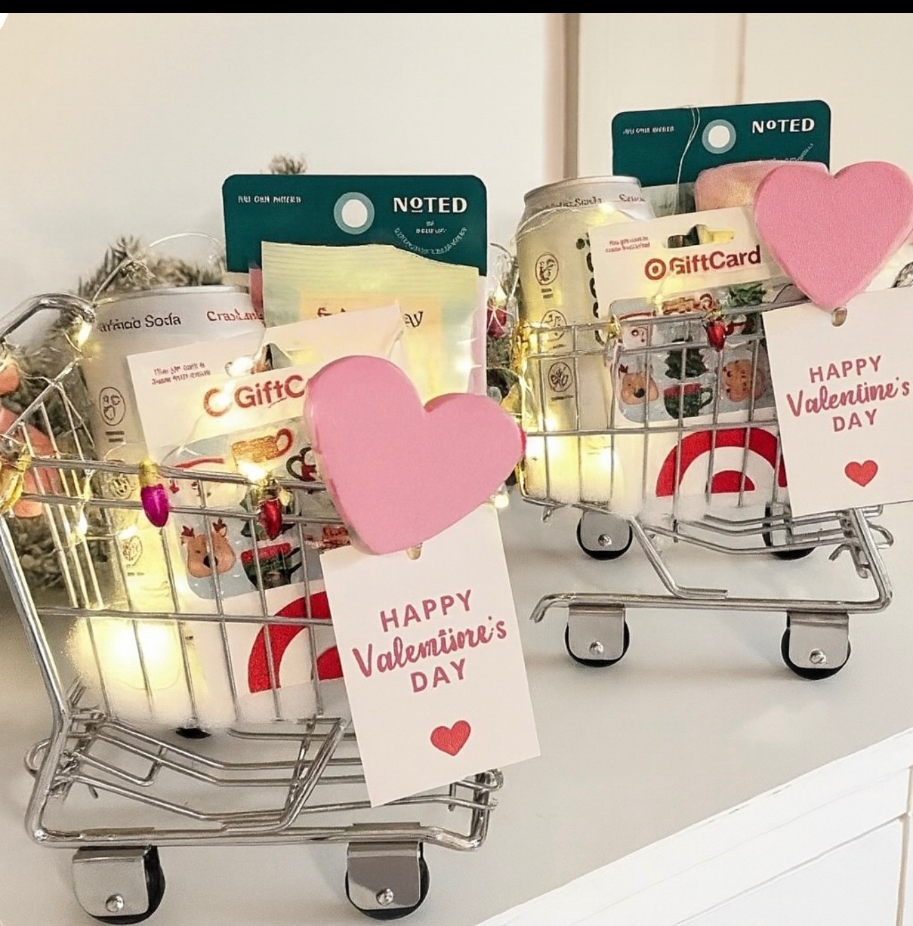 #valentines A soft, dreamy Valentine’s aesthetic featuring two mini silver shopping carts styled as romantic gift baskets. Each cart is filled with cozy, feel-good treats — sparkling sodas, self-care minis, pastel stationery, and Target gift cards tucked neatly inside. Warm fairy lights weave through the carts, creating a glowing, magical ambiance. Soft pink heart cutouts clip the “Happy Valentine’s Day” tags to the front, adding a charming, handcrafted touch. The background is clean and bright, with hints of soft garland that keep the focus on the baskets. The overall vibe is cute-minimalist, feminine, and Pinterest-perfect — ideal for gifting, flat lays, or aesthetic holiday inspiration.

⸻

❤️ Hashtags

#valentinesday
#valentinesgiftideas
#valentinesaesthetic
#valentinesbasket
#giftbasketideas
#targetfinds
#minicart
#pinterestinspired
#prettylittlethings
#holidayaesthetic
#ltkhome
#ltkseasonal
#trendygifts
#selfcaregifts
#pinkdecor
#cutegiftideas
#romanticvibes
#pinterestworthy
#valentinescrafts
#targetstyle
#targetlover
#giftsforher
#giftsforhim
#cozyaesthetic
#trendyheidi


#LTKGiftGuide #LTKHoliday #LTKdayinmylife