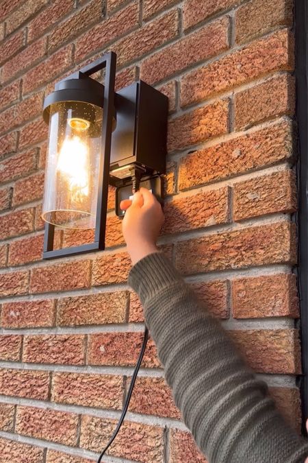 An outdoor wall light that also functions as an outlet! Perfect for a porch like mine that doesn't have an electrical outlets. Now we can plug in our phones or our Christmas lights without needing to run extensions chords from the garage! 

#LTKhome #LTKfindsunder100 #LTKstyletip