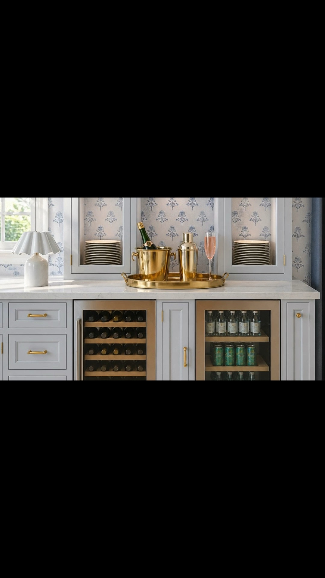 An evening bar moment at home. 🥂

As the day winds down, this built-in station is ready for a glass of wine, a cocktail, or friends gathering around for the evening. Soft cabinet lighting makes the pink glassware glow against the blue floral wallpaper, while glass shelves and stacks of plates keep everything beautifully arranged and close at hand.

On the marble counter, a brass tray holds the champagne bucket, cocktail shaker, and a flute poured for the occasion. The pleated rechargeable table lamp adds a warm glow beside the window, and the tailored Roman shade and drapery finish the space. Below, the under-counter wine cooler and beverage fridge keep bottles and drinks chilled and ready to serve.

Cheers to a beautiful night at home. ✨

#HomeBar #BarStation #EveningAtHome #CocktailHour #WineCooler #BeverageFridge #UnderCounterFridge #Barware #Drinkware #PinkGlassware #RechargeableTableLamp #Wallpaper #BuiltInBar #EntertainingAtHome #KitchenDesign #RomanShade #Drapery #MarbleCountertop #BrassDecor #LTKHome #LTKdayinmylife #LTKVlog #LTKSaleAlert

#LTKdayinmylife #LTKHome #LTKSaleAlert