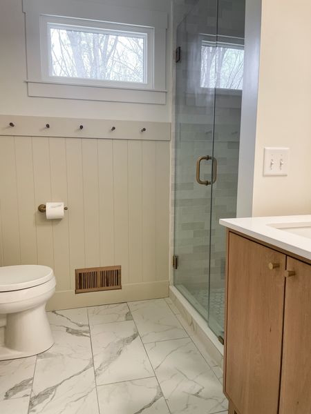 We updated our master bathroom with a matching white oak vent cover to our white oak vanity.  

Bathroom finishes.  Shiplap panel.  Mission pegs.  White oak vanity.  Bathroom porcelain floor tile.  Vent cover.  Kohler toilet.  Shower glass door.  

#LTKhome #LTKfamily #LTKstyletip