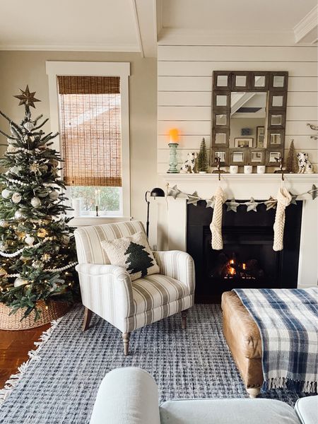 Striped small accent arm chair (color options), tree pillow (color and size options), blue plaid throw blanket, blue rug, similar mirror, similar black pharmacy floor lamp, battery operated window candle (set of  4, color options)

#LTKHoliday #LTKSeasonal #LTKhome