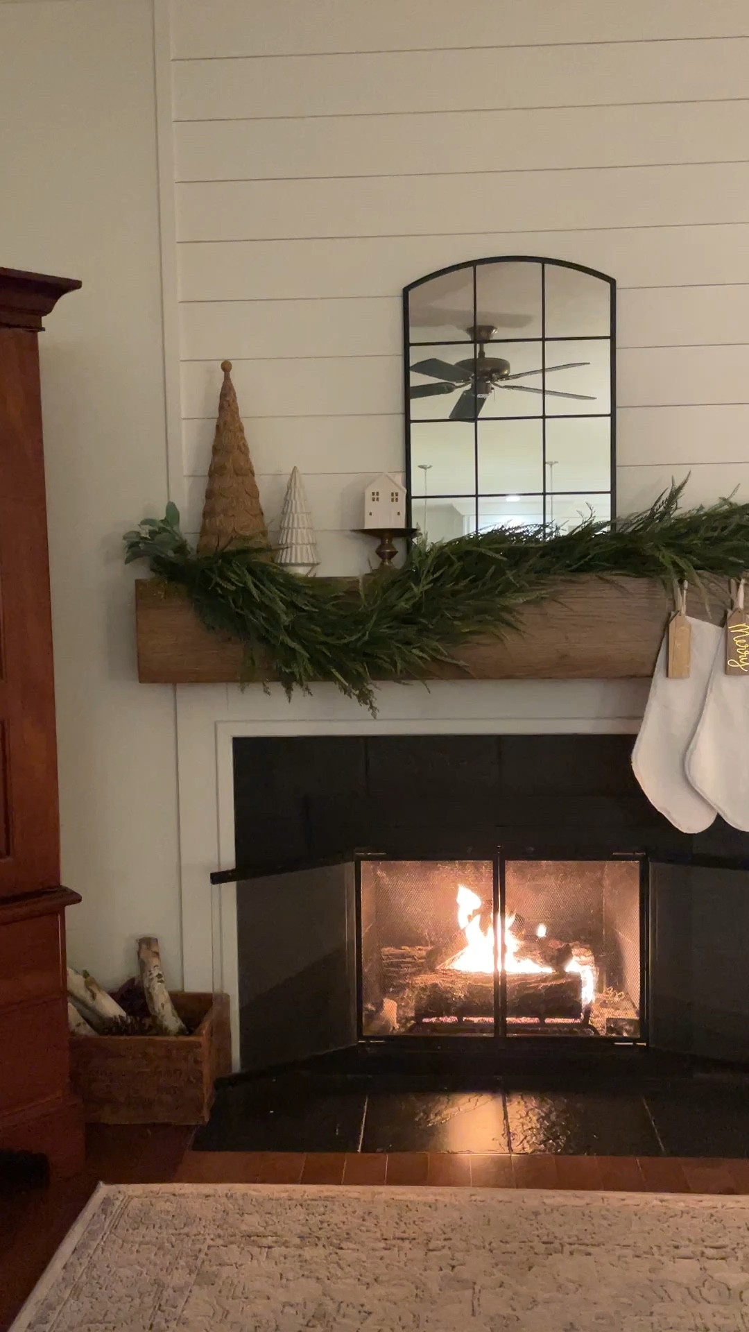 Christmas fireplace mantel styling.  

White stockings.  Garland.  Cone tree.  Small ceramic Christmas trees.  Stocking holders.  

#LTKWatchNow #LTKHoliday #LTKHome